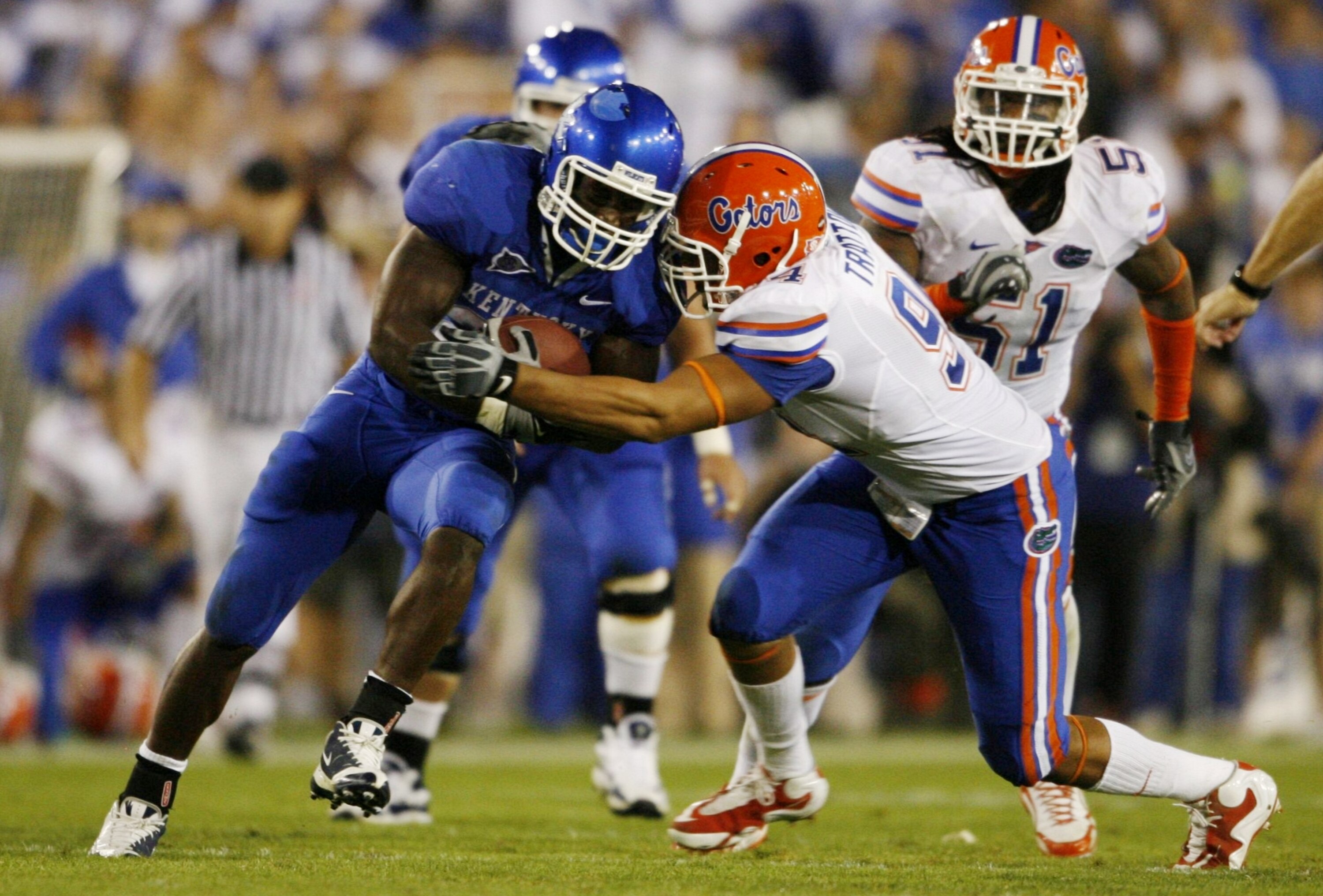 LEXINGTON, KY - SEPTEMBER 26:  Runningback Alfonso Smith #29 of the Kentucky Wildcats is tackled by Justin Trattou #94 of the Florida Gators in the fourth quarter of the game  at Commonwealth Stadium on September 26, 2009 in Lexington, Kentucky. The Gator