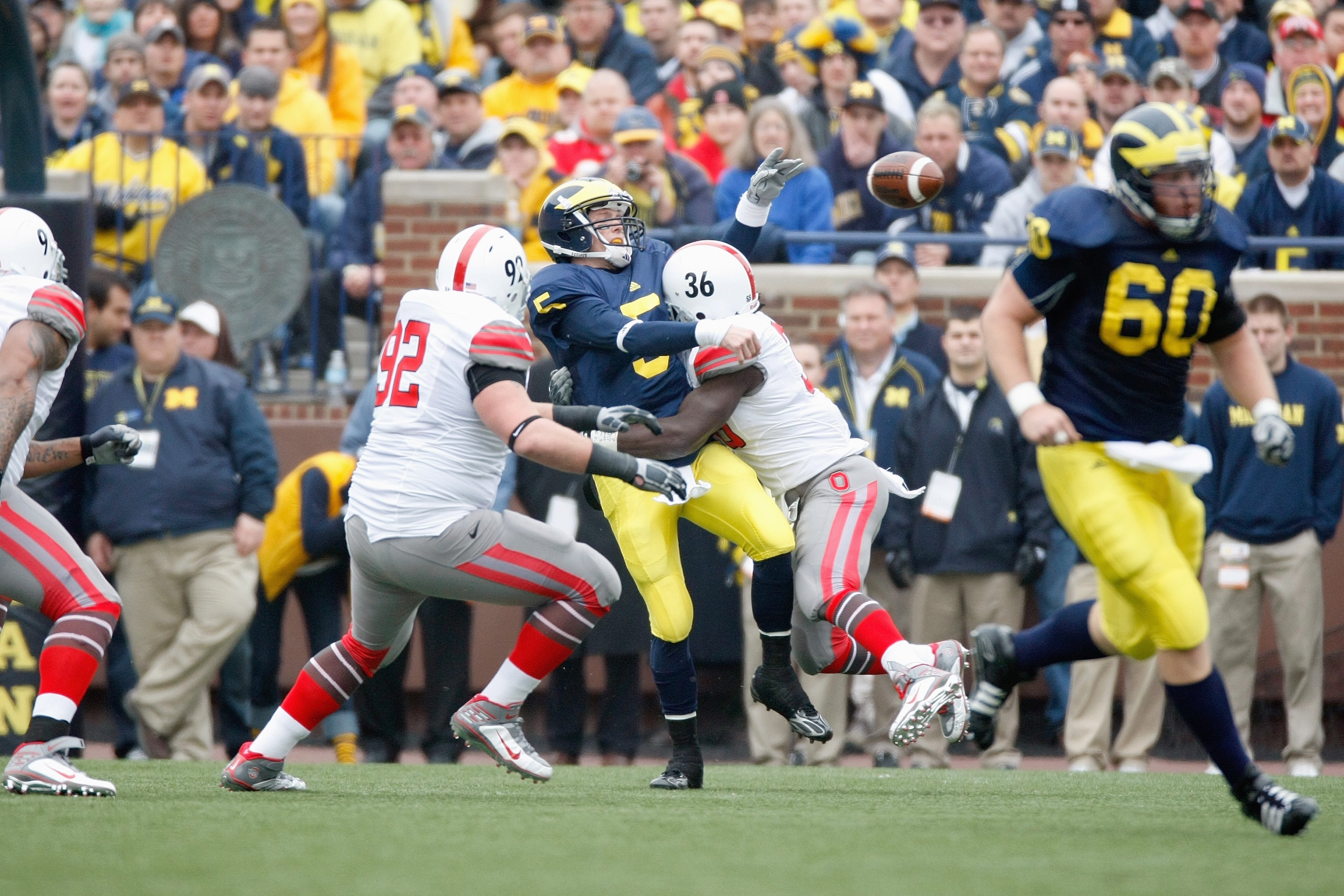 ANN ARBOR, MI - NOVEMBER 21:  Quarterback Tate Forcier #5 of the Michigan Wolverines is sacked by Brian Rolle #36 the Ohio State Buckeyes on November 21, 2009 at Michigan Stadium in Ann Arbor, Michigan. Ohio State won the game 21-10. (Photo by Gregory Sha