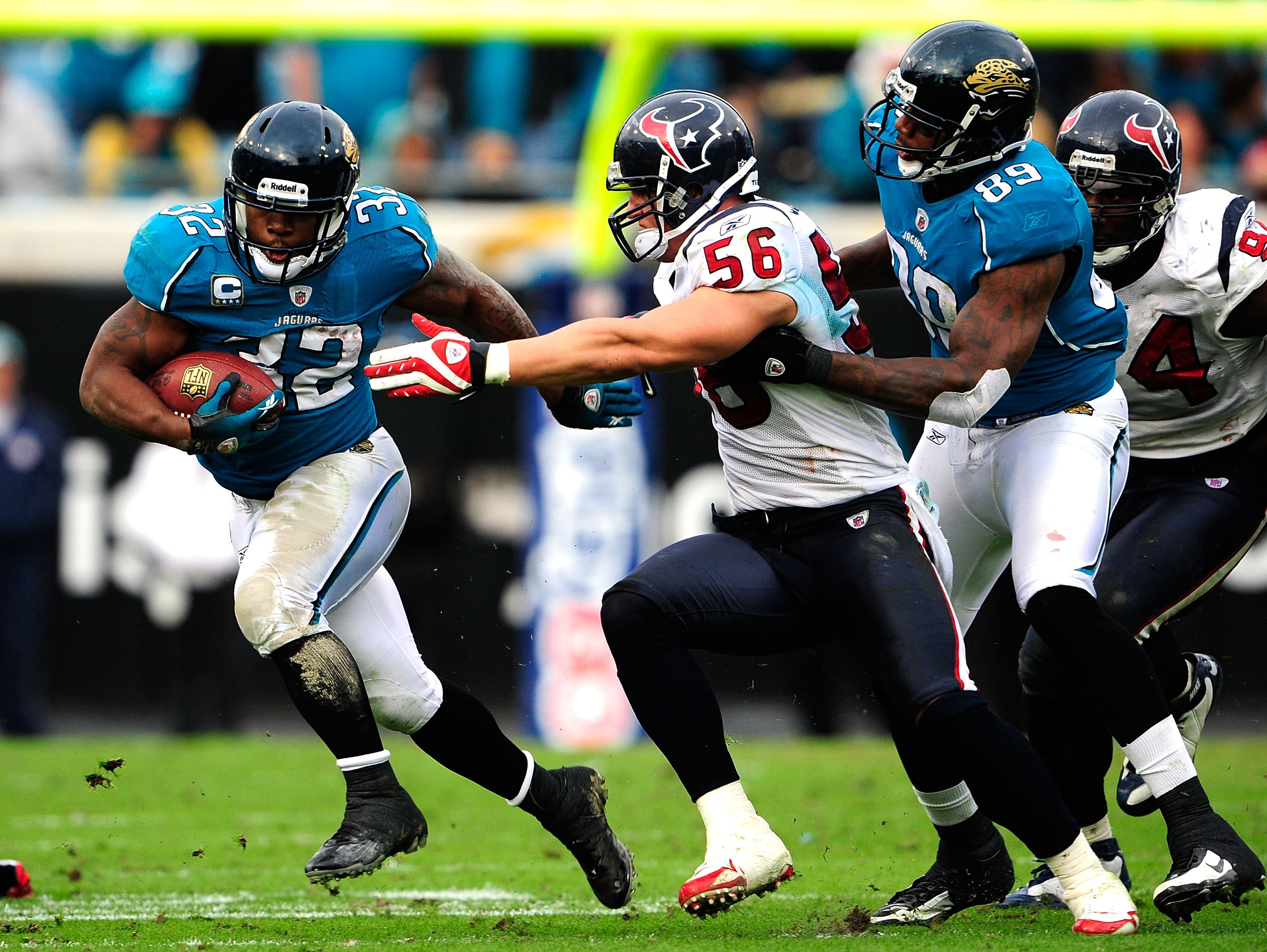 JACKSONVILLE, FL - DECEMBER 06:  Brian Cushing #56 of the Houston Texans attempts to tackle Maurice Jones-Drew #32 of the Jacksonville Jaguars during the game at Jacksonville Municipal Stadium on December 6, 2009 in Jacksonville, Florida.  (Photo by Sam G