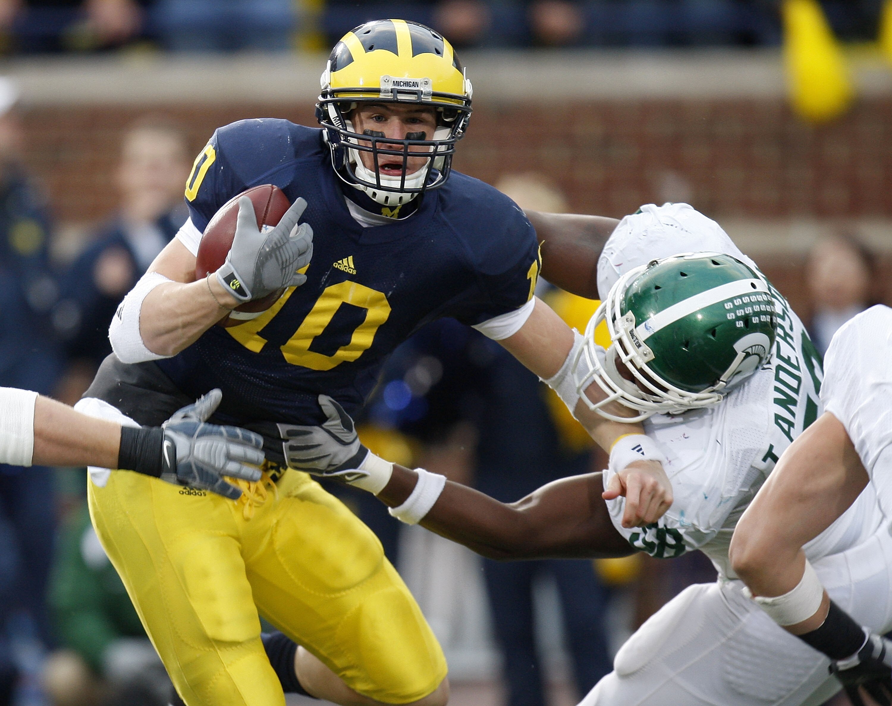 ANN ARBOR, MI - OCTOBER 25: Steven Threet #10 of the Michigan Wolverines tries to get around the tackle of Todd Anderson #58 of the Michigan State Spartans during a third quarter sack on October 25, 2008 at Michigan Stadium in Ann Arbor, Michigan. Michiga