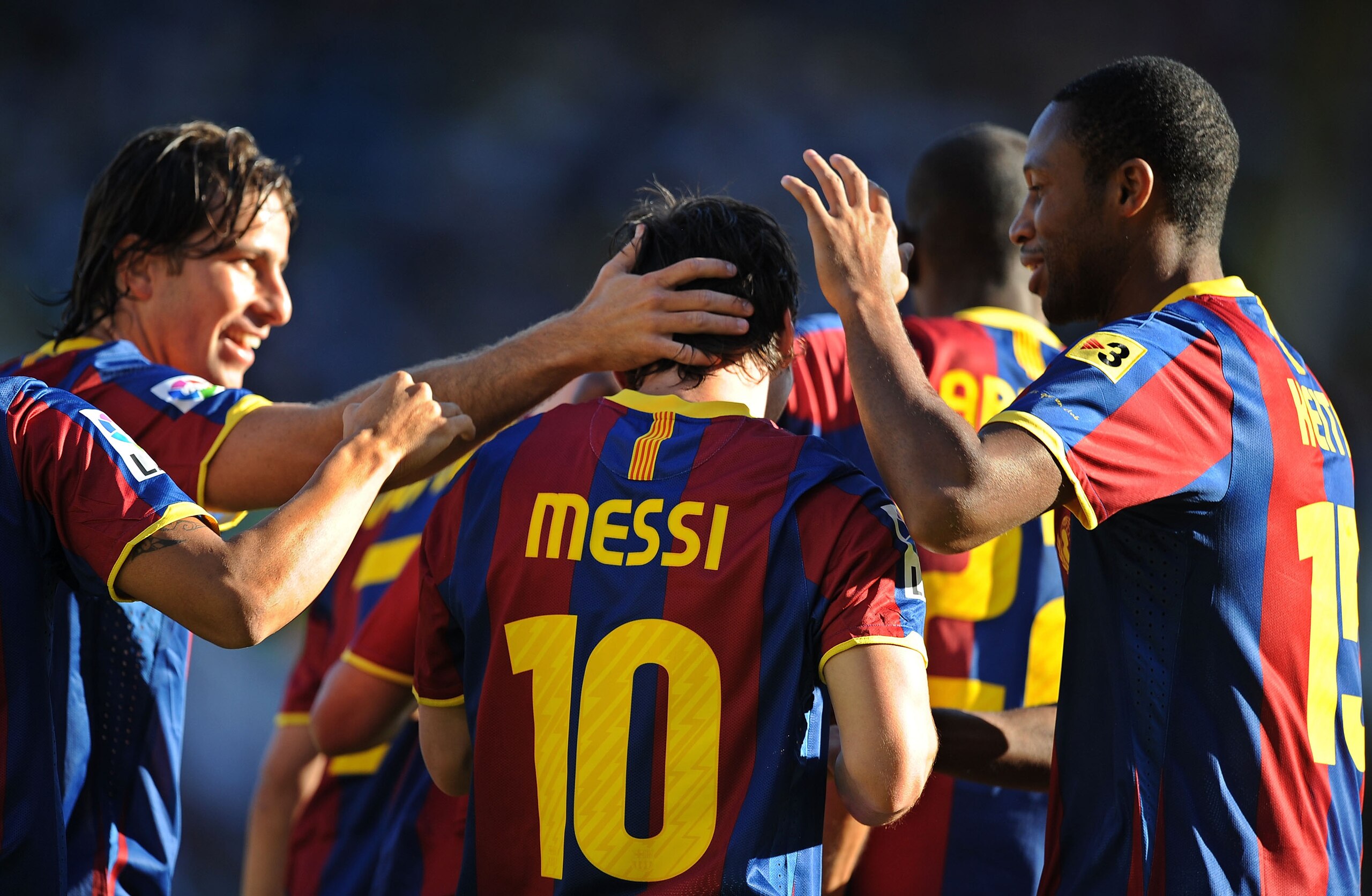 SANTANDER, SPAIN - AUGUST 29:  Leo Messi of Barcelona celebrates with Maxwell Scherrer  (L) and  Seydou Keita after scoring Barcelona's first goal during the La Liga match between Racing Santander and Barcelona at El Sardinero stadium on August 29, 2010 i