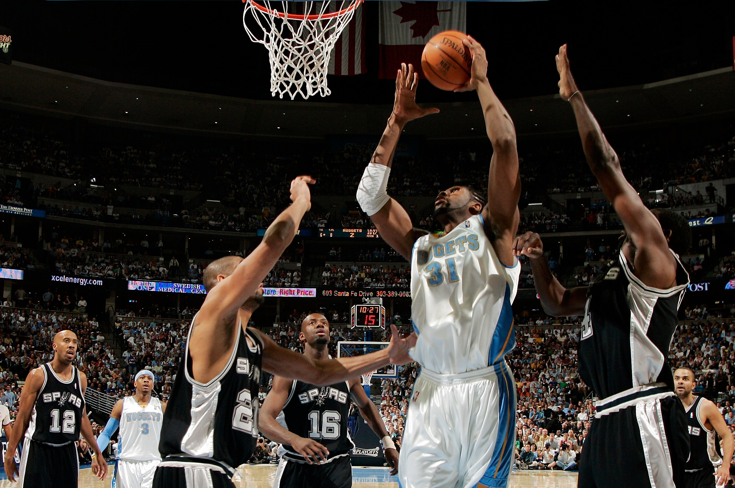 DENVER - APRIL 30:  Nene #31 of the Denver Nuggets goes up against Tim Duncan #21, Michael Finley #4, and Francisco Elson #16 of the San Antonio Spurs in the first quarter of Game Four of the Western Conference Quarterfinals during the 2007 NBA Playoffs a