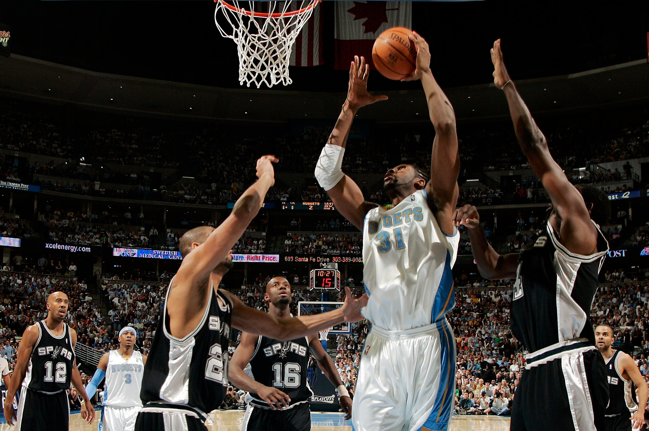 DENVER - APRIL 30:  Nene #31 of the Denver Nuggets goes up against Tim Duncan #21, Michael Finley #4, and Francisco Elson #16 of the San Antonio Spurs in the first quarter of Game Four of the Western Conference Quarterfinals during the 2007 NBA Playoffs a