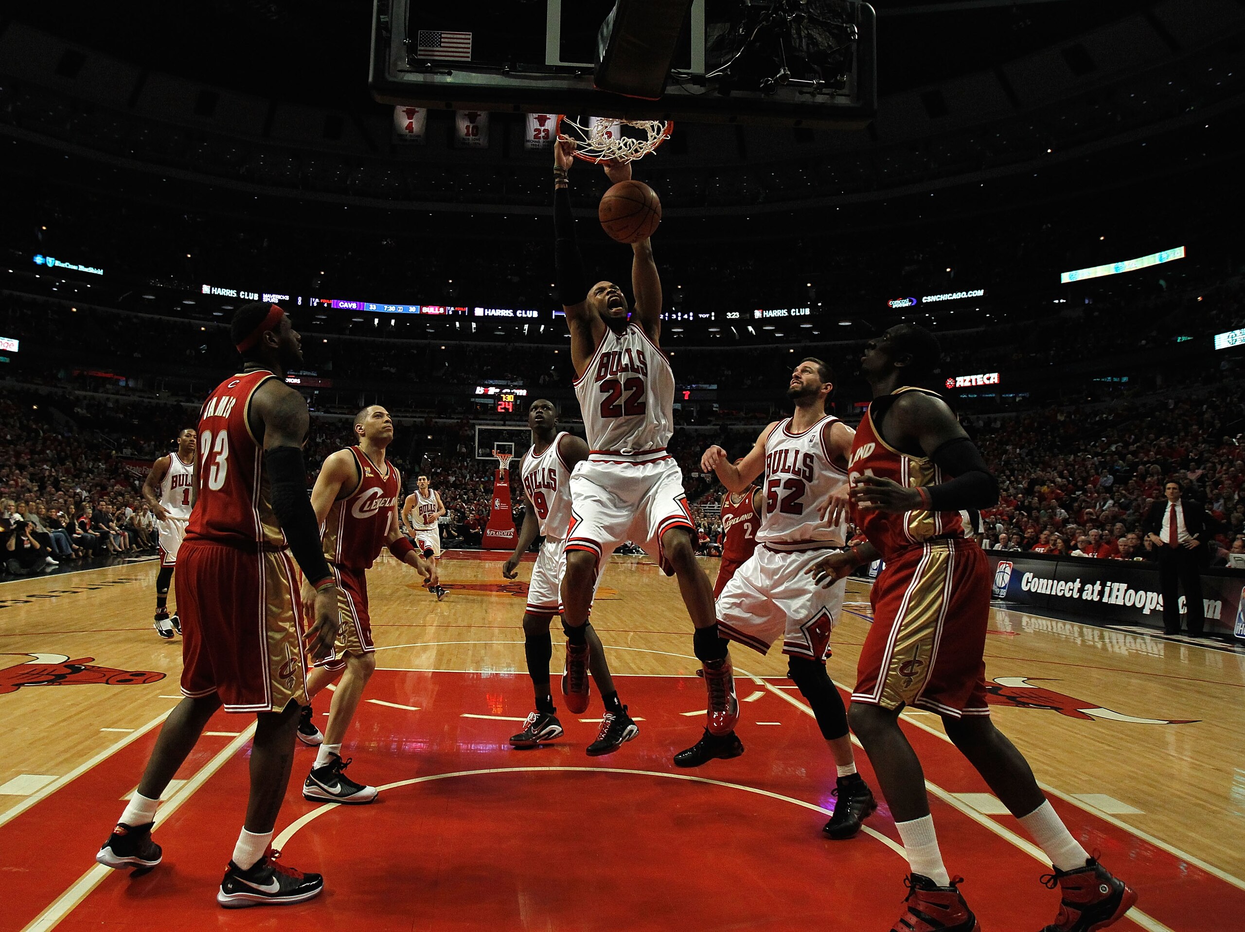 CHICAGO - APRIL 25: Taj Gibson #22 of the Chicago Bulls dunks the ball over teammates Luol Deng #9 and Brad Miller #52 as well as LeBron James #23, Anthony Parker #18 and J.J. Hickson #21 of the Cleveland Cavaliers in Game Four of the Eastern Conference Q