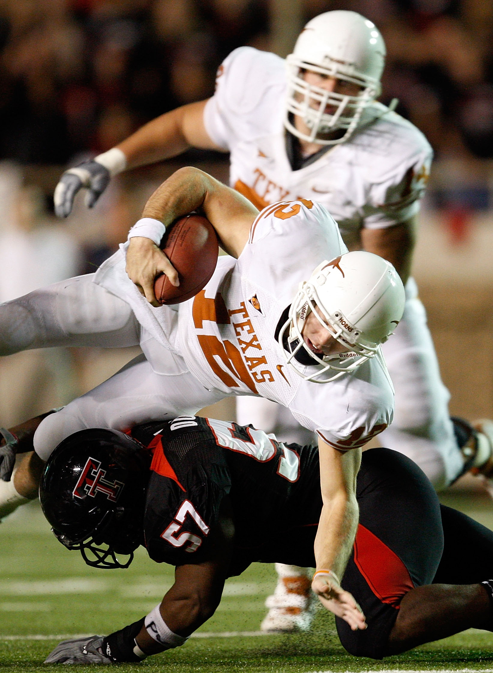 LUBBOCK, TX - NOVEMBER 01:  Quarterback Colt McCoy #12 of the Texas Longhorns carries the ball as he is upended by Brian Duncan #57 of the Texas Tech Red Raiders on November 1, 2008 at Jones Stadium in Lubbock, Texas.  (Photo by Jamie Squire/Getty Images)
