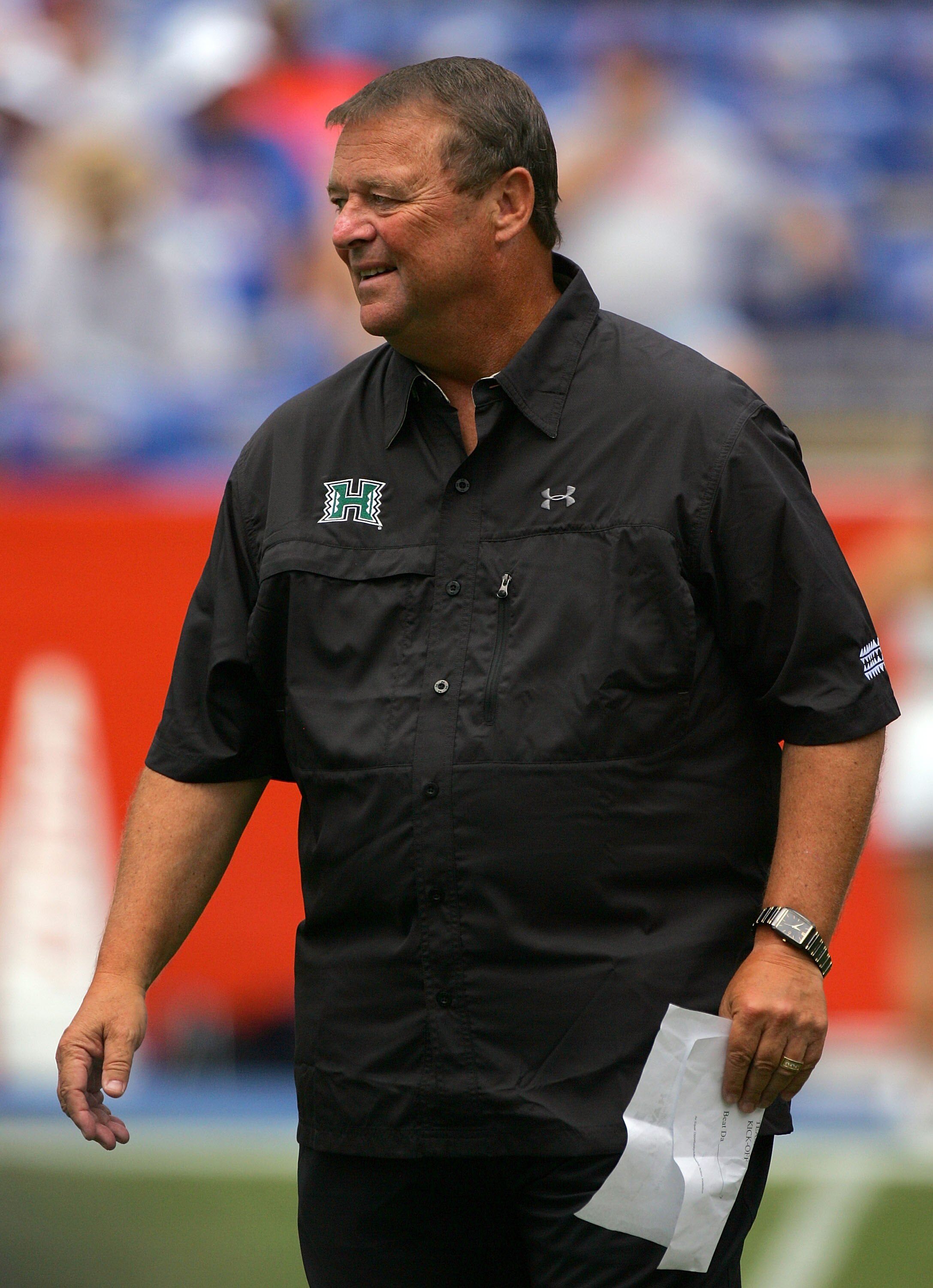 GAINESVILLE, FL - AUGUST 30:  Head coach Greg McMackin of the Hawaii Warriors sends in signals during the game against the Florida Gators at Ben Hill Griffin Stadium on August 30, 2008 in Gainesville, Florida.  (Photo by Sam Greenwood/Getty Images)