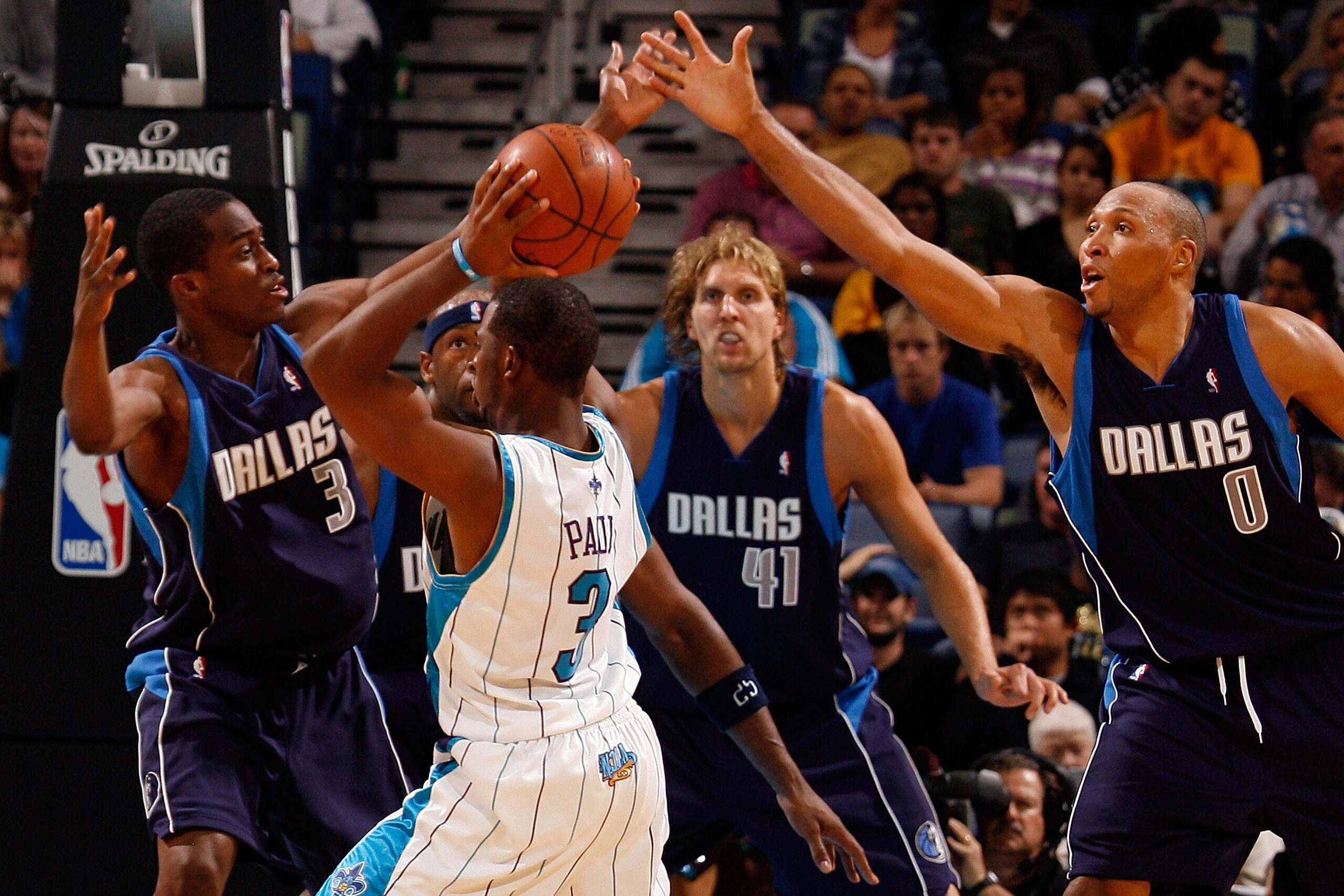 NEW ORLEANS - NOVEMBER 04:  Chris Paul #3 of the New Orleans Hornets looks to pass the ball around Rodrigue Beaubois #3 and Shawn Marion #0 of the Dallas Mavericks at New Orleans Arena on November 4, 2009 in New Orleans, Louisiana.  NOTE TO USER: User exp