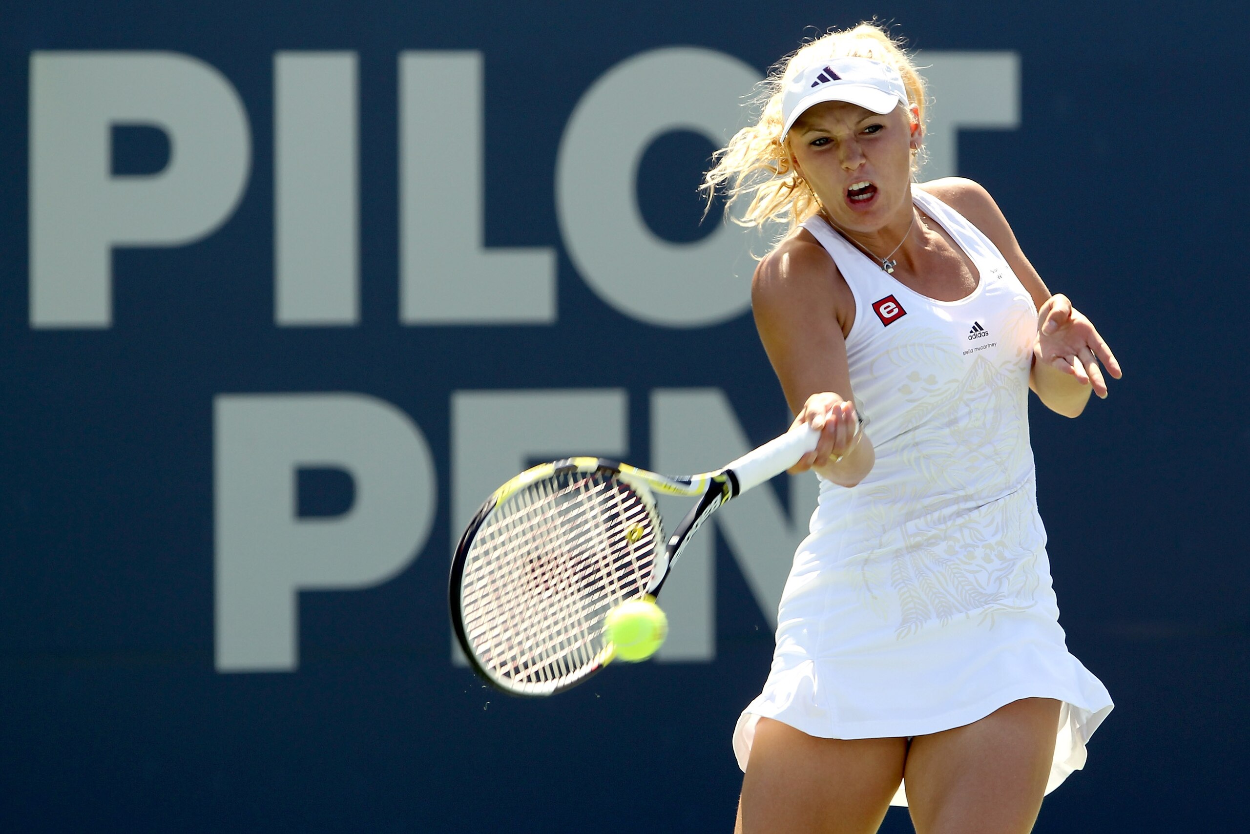 NEW HAVEN, CT - AUGUST 28:  Top seed Caroline Wozniacki of Denmark returns a shot to Nadia Petrova of Russia during the final of the Pilot Pen tennis tournament at the Connecticut Tennis Center on August 28, 2010 in New Haven, Connecticut. Wozniacki beat