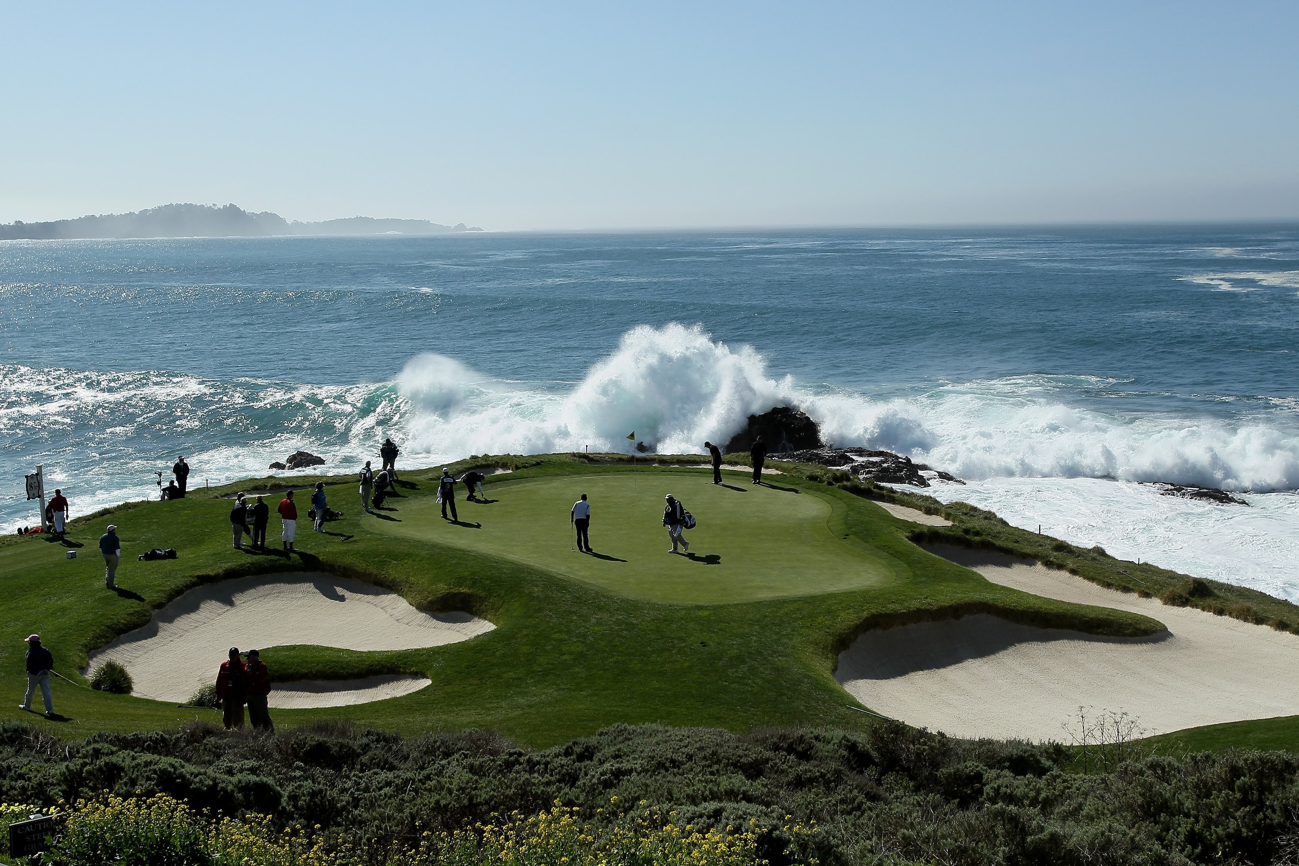 PEBBLE BEACH, CA - FEBRUARY 14:  Surf crashes as a group plays the seventh hole during the final round of the AT&T Pebble Beach National Pro-Am at Pebble Beach Golf Links on February 14, 2010 in Pebble Beach, California.  (Photo by Stephen Dunn/Getty Imag