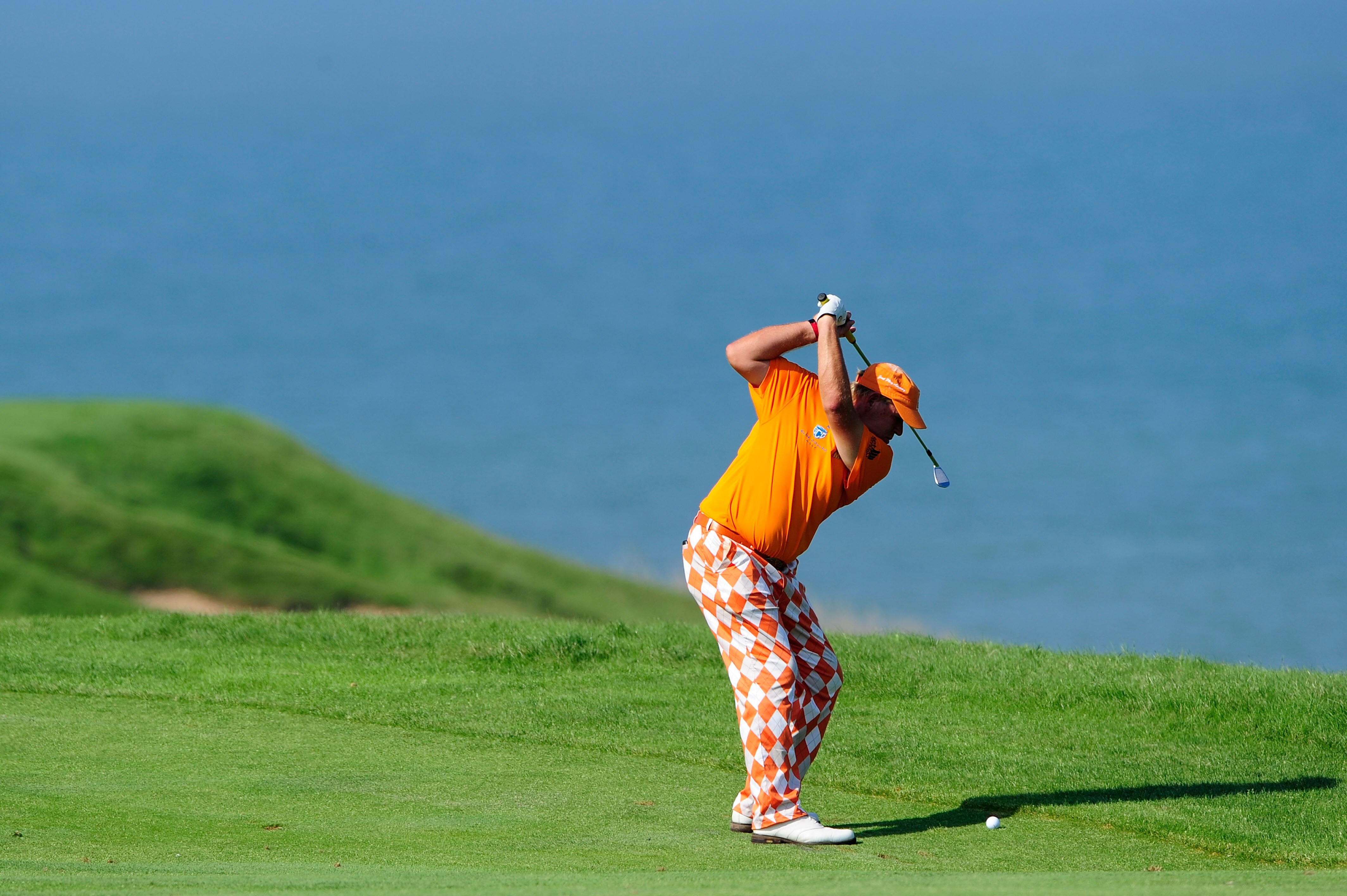 KOHLER, WI - AUGUST 12:  John Daly hits his approach shot on the eighth hole during the first round of the 92nd PGA Championship on the Straits Course at Whistling Straits on August 12, 2010 in Kohler, Wisconsin.  (Photo by Stuart Franklin/Getty Images)