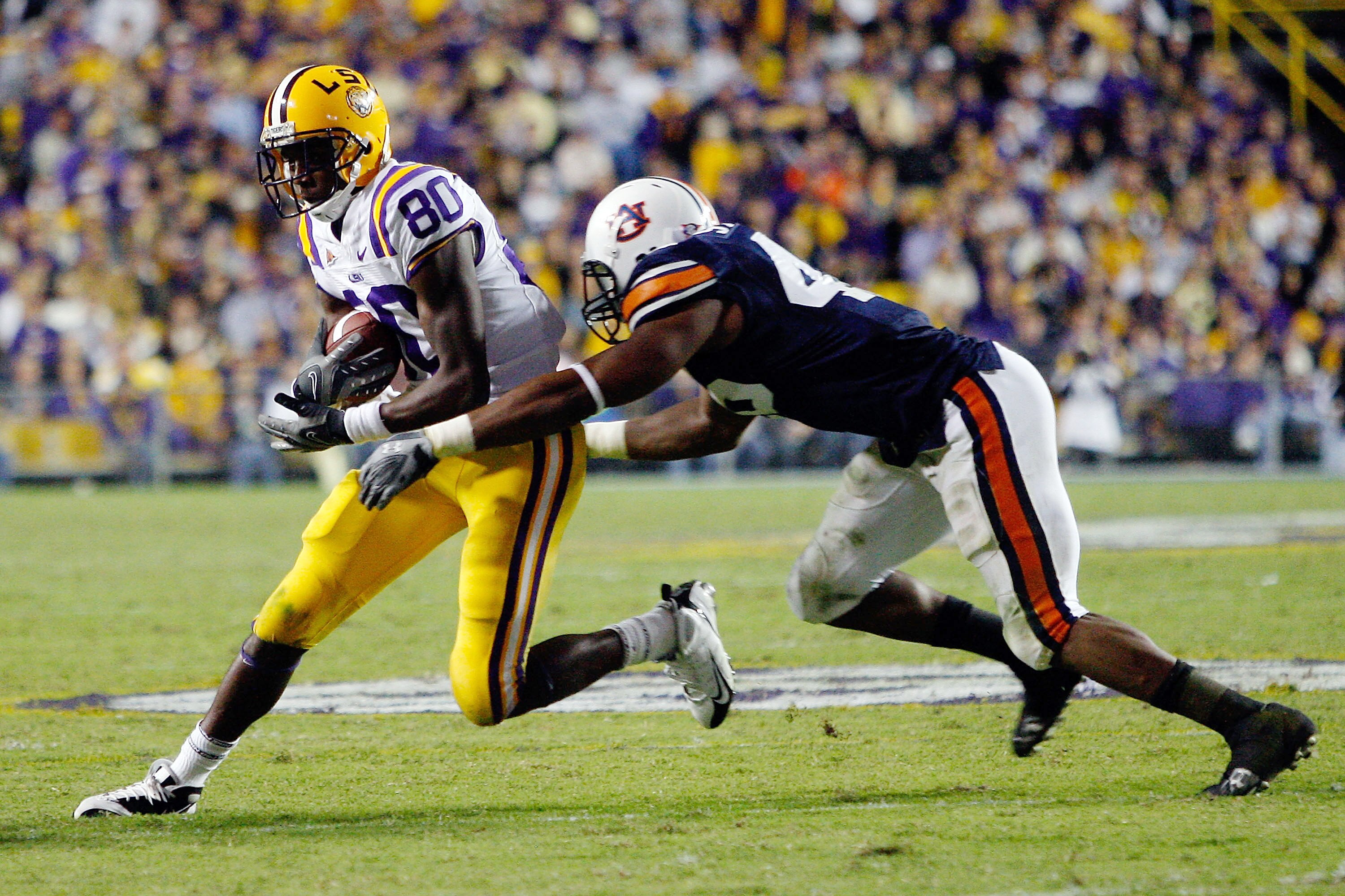 BATON ROUGE, LA - OCTOBER 24:  Terrance Toliver #80 of the Louisiana State University Tigers is tackled by Antoine Carter #45 of the Auburn Tigers at Tiger Stadium on October 24, 2009 in Baton Rouge, Louisiana.  (Photo by Chris Graythen/Getty Images)