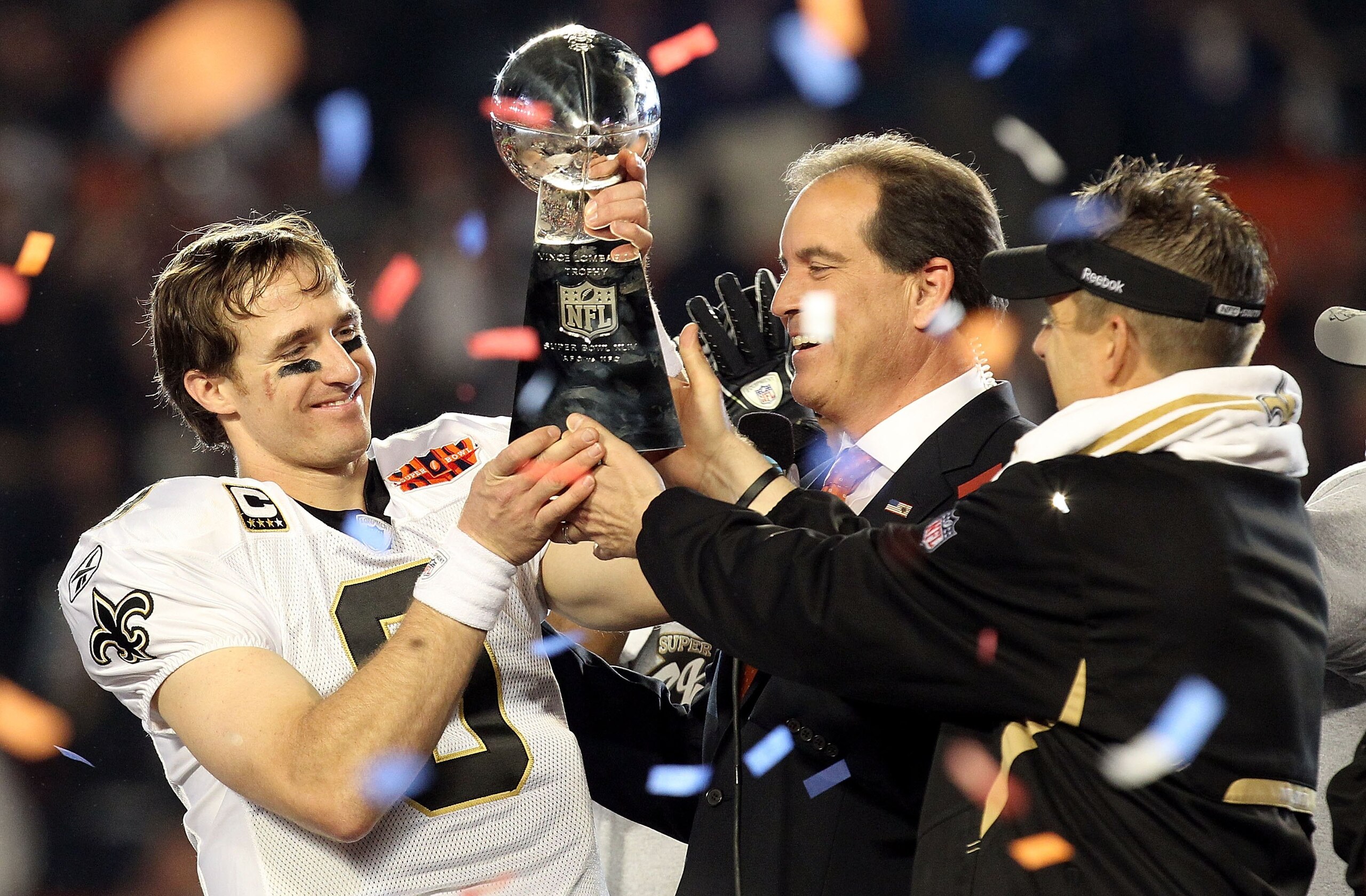 MIAMI GARDENS, FL - FEBRUARY 07:  Head coach Sean Payton of the New Orleans Saints passes quarterback Drew Brees #9 the Vince Lombardi trophy after defeating the Indianapolis Colts during Super Bowl XLIV on February 7, 2010 at Sun Life Stadium in Miami Ga