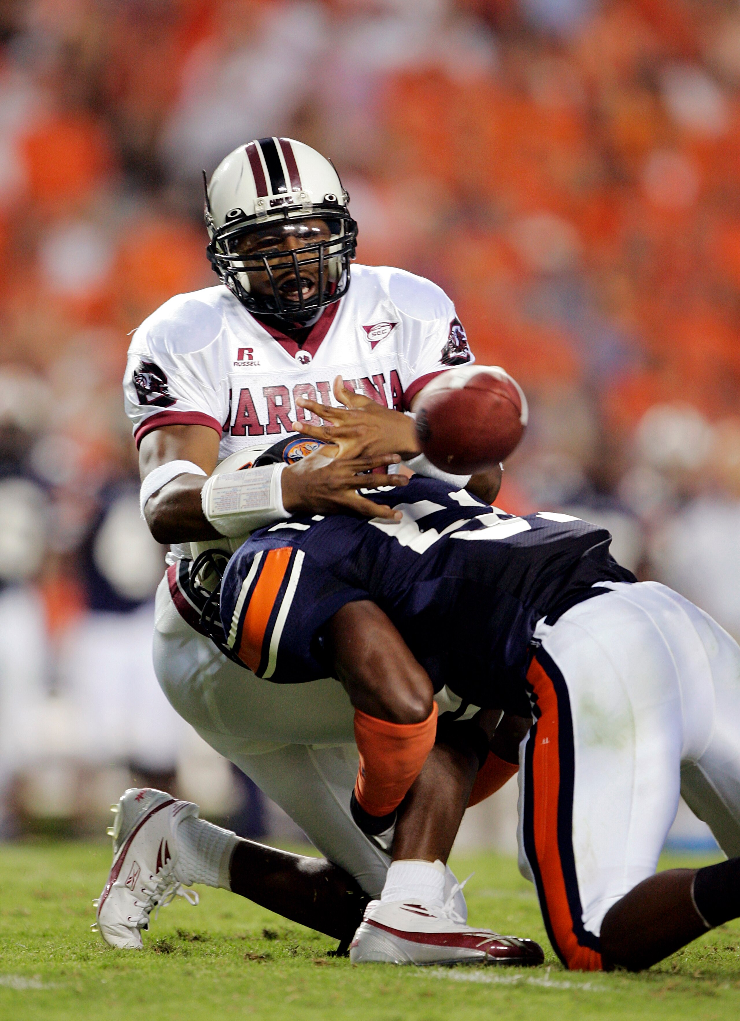 AUBURN, AL - OCTOBER 1:  Redshirt freshman quarterback Antonio Heffner #18 of the South Carolina Gamecocks fumbles the ball for a turnover as he is hit by linebacker Travis Williams #51 of the Auburn Tigers in the first quarter on October 1, 2005 at Jorda