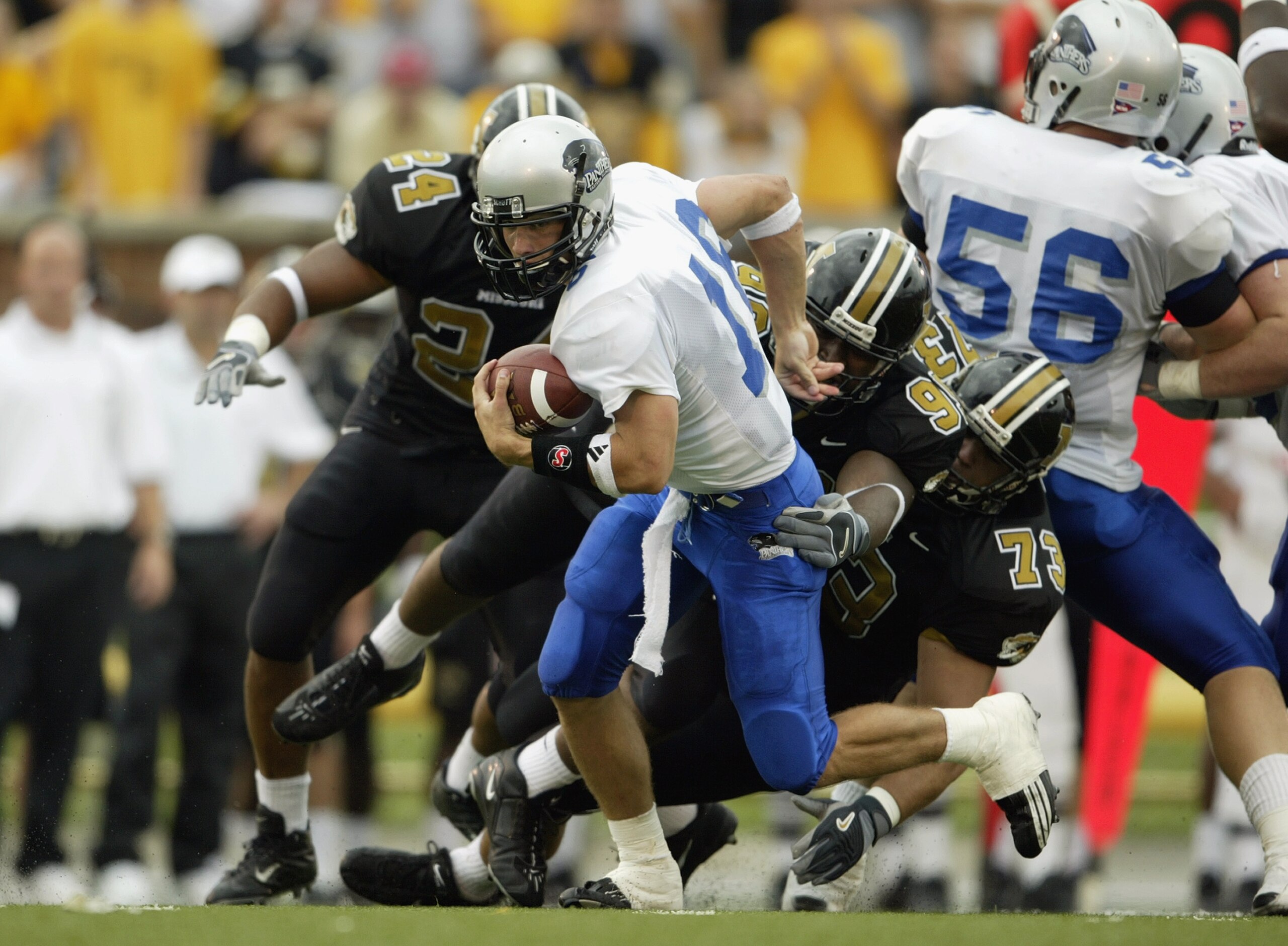 COLUMBIA, MO - SEPTEMBER 13: Andy Vincent #16 of the Eastern Illinois Panthers runs with the ball as he tries to escape the grasp of C. J. Mosley #99 of the Missouri Tigers on September 13, 2003 at Memorial Stadium in Columbia, Missouri. Missouri defeat COLUMBIA, MO - SEPTEMBER 13: Andy Vincent #16 of the Eastern Illinois Panthers runs with the ball as he tries to escape the grasp of C. J. Mosley #99 of the Missouri Tigers on September 13, 2003 at Memorial Stadium in Columbia, Missouri. Missouri defeat