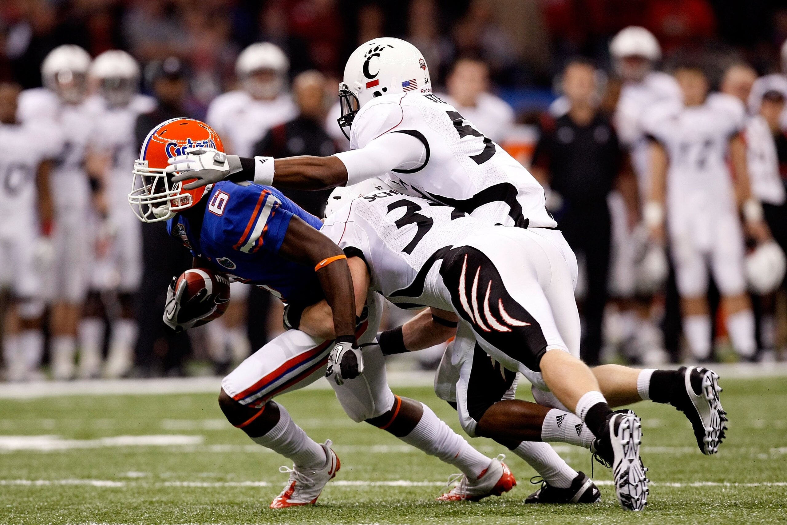 NEW ORLEANS - JANUARY 01: Deonte Thompson #6 of the Florida Gators gets tackled by J.K. Schaffer #37 of the Cincinnati Bearcats during the Allstate Sugar Bowl at the Louisana Superdome on January 1, 2010 in New Orleans, Louisiana. (Photo by Kevin C. Cox NEW ORLEANS - JANUARY 01: Deonte Thompson #6 of the Florida Gators gets tackled by J.K. Schaffer #37 of the Cincinnati Bearcats during the Allstate Sugar Bowl at the Louisana Superdome on January 1, 2010 in New Orleans, Louisiana. (Photo by Kevin C. Cox