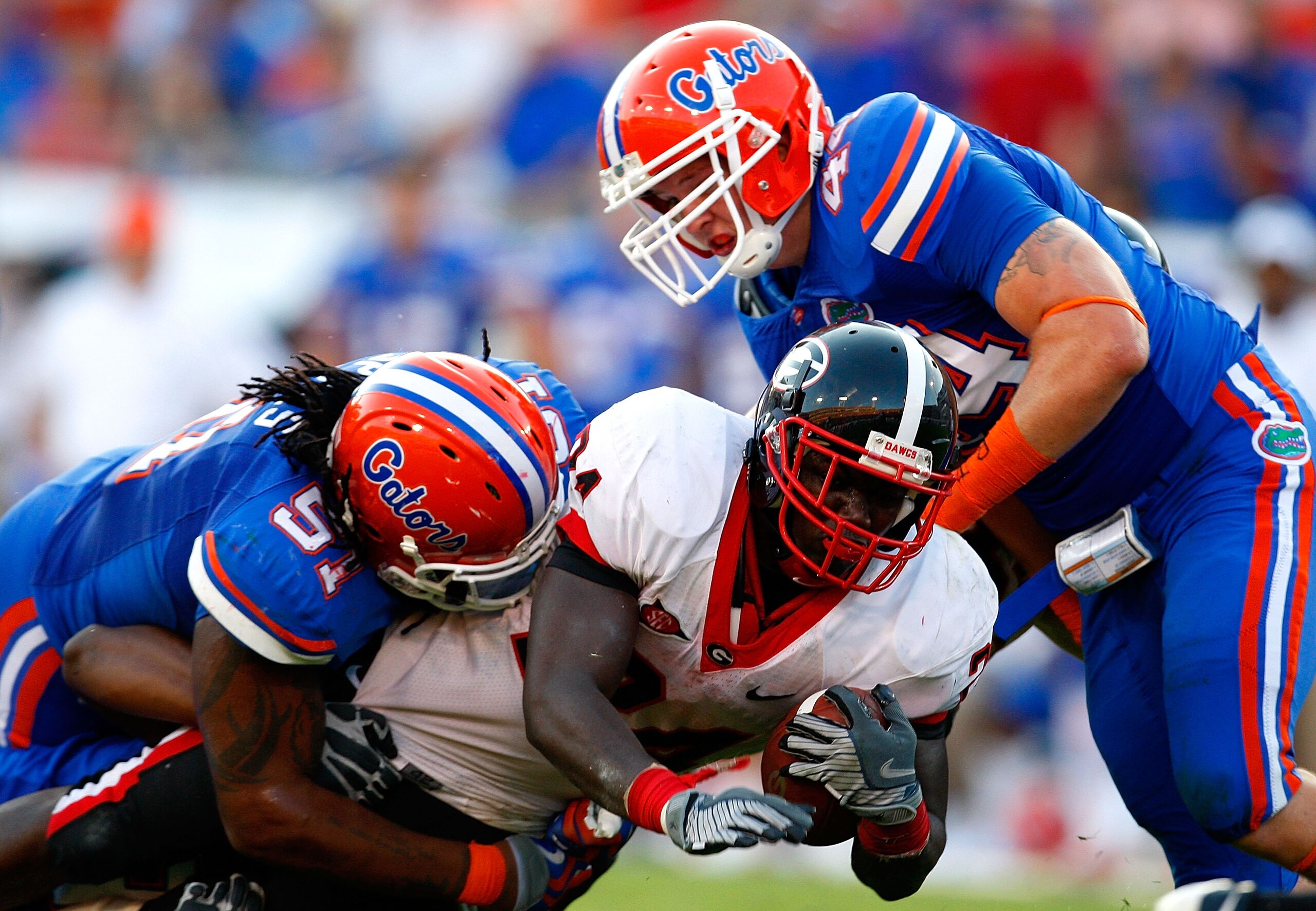 JACKSONVILLE, FL - OCTOBER 31:  Brandon Spikes #51 and Duke Lemmens #44 of the Florida Gators tackle Washaun Ealey #24 of the Georgia Bulldogs at Jacksonville Municipal Stadium on October 31, 2009 in Jacksonville, Florida.  (Photo by Kevin C. Cox/Getty Im