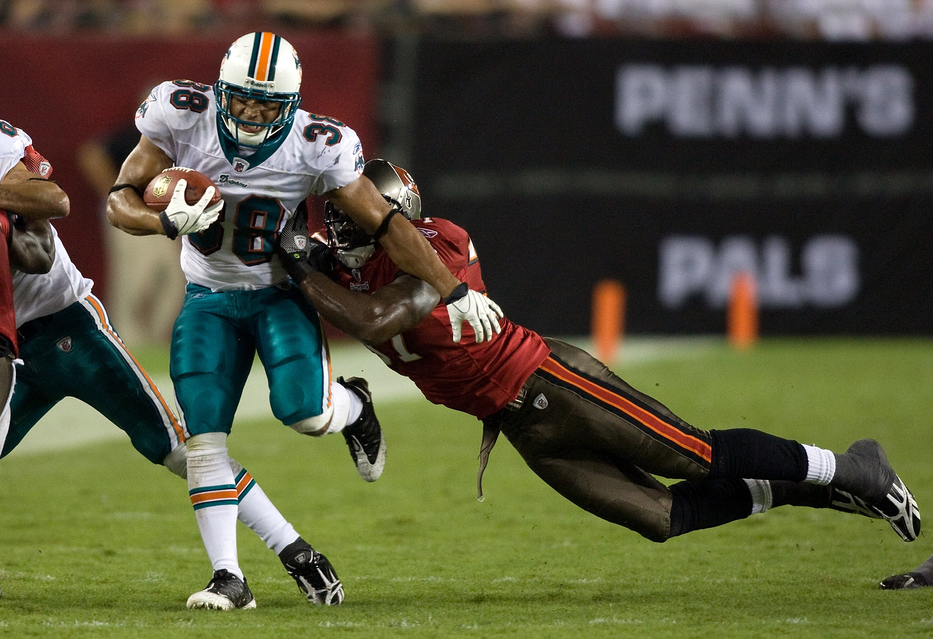 TAMPA, FL - AUGUST 27: Running back Patrick Cobbs #38 of the Miami Dolphins is tackled by defender Steve Cargile #37 of the Tampa Bay Buccaneers during a preseason game at Raymond James Stadium on August 27, 2009 in Tampa, Florida. (Photo by J. Meric/G TAMPA, FL - AUGUST 27: Running back Patrick Cobbs #38 of the Miami Dolphins is tackled by defender Steve Cargile #37 of the Tampa Bay Buccaneers during a preseason game at Raymond James Stadium on August 27, 2009 in Tampa, Florida. (Photo by J. Meric/G