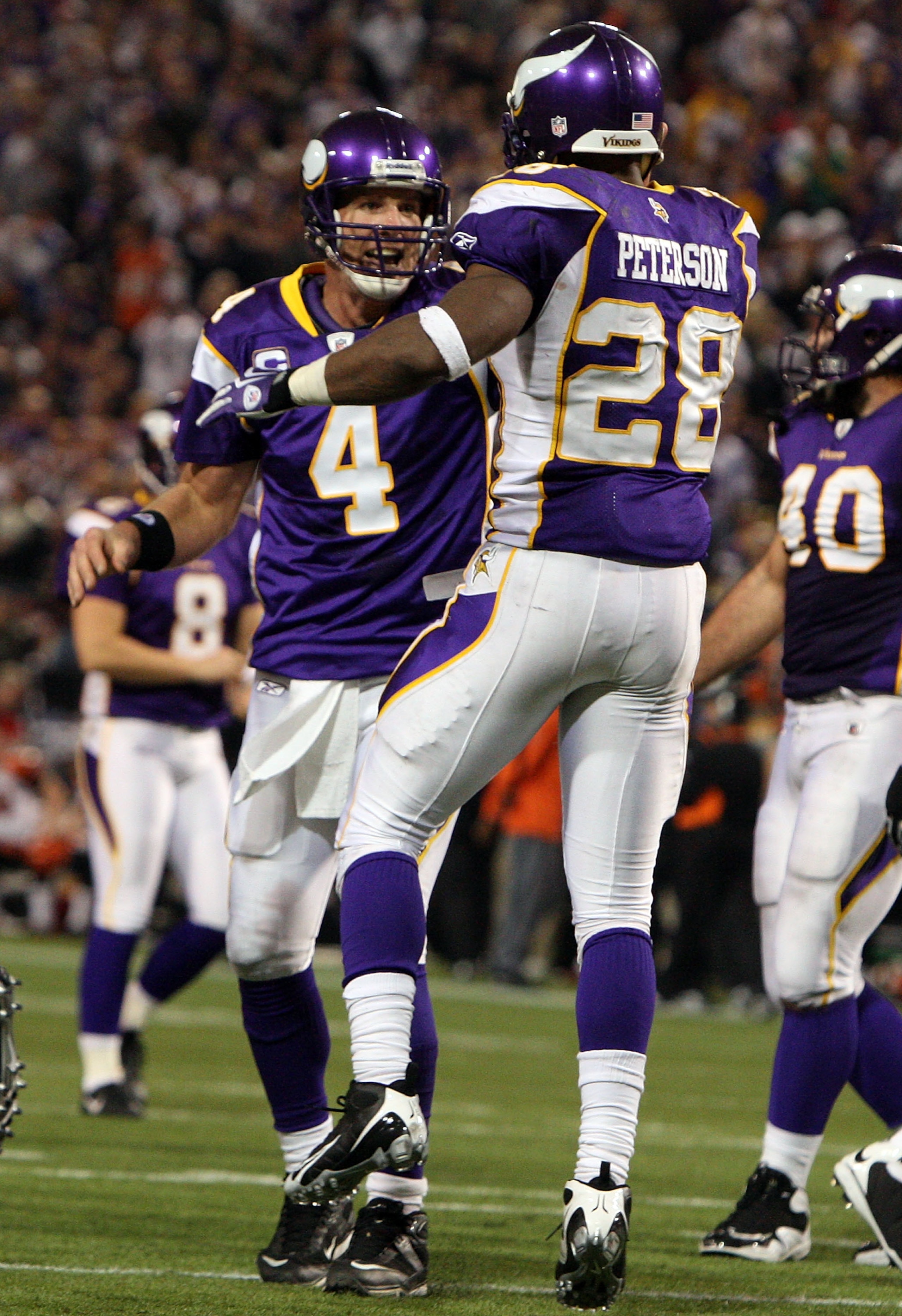 MINNEAPOLIS, MN - DECEMBER 13:  Adrian Peterson #28 of the Minnesota Vikings celebrates his third quarter touchdown against the Cincinnati Bengals with teammate Brett Favre #4 on December 13, 2009 at Hubert H. Humphrey Metrodome in Minneapolis, Minnesota.