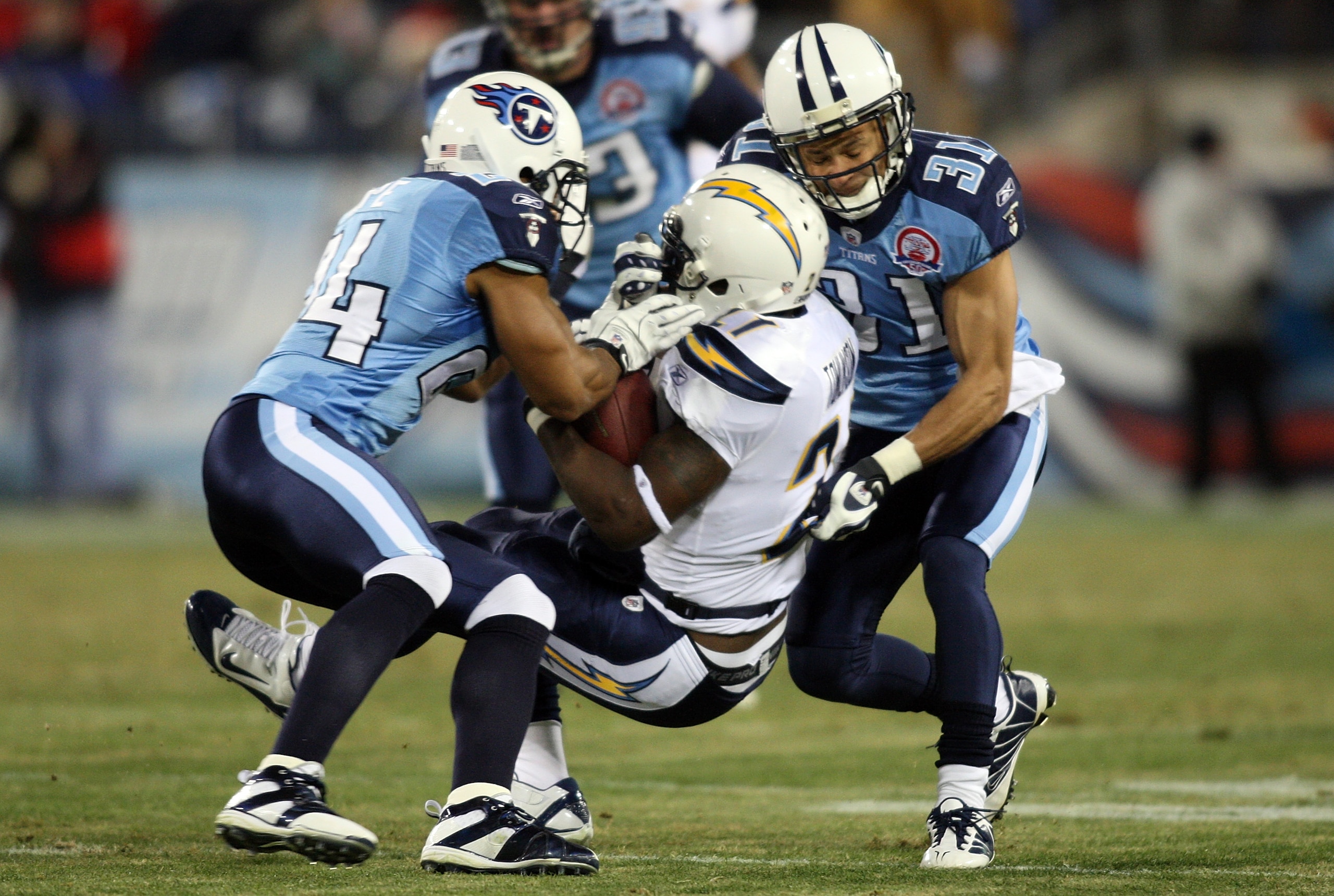 NASHVILLE, TN - DECEMBER 25: Chris Hope #24 and Cortland Finnegan #31 of the Tennessee Titans bring down LaDainian Tomlinson #21 of the San Diego Chargers on December 25, 2009 at LP Field in Nashville, Tennessee. (Photo by Rex Brown/Getty Images)