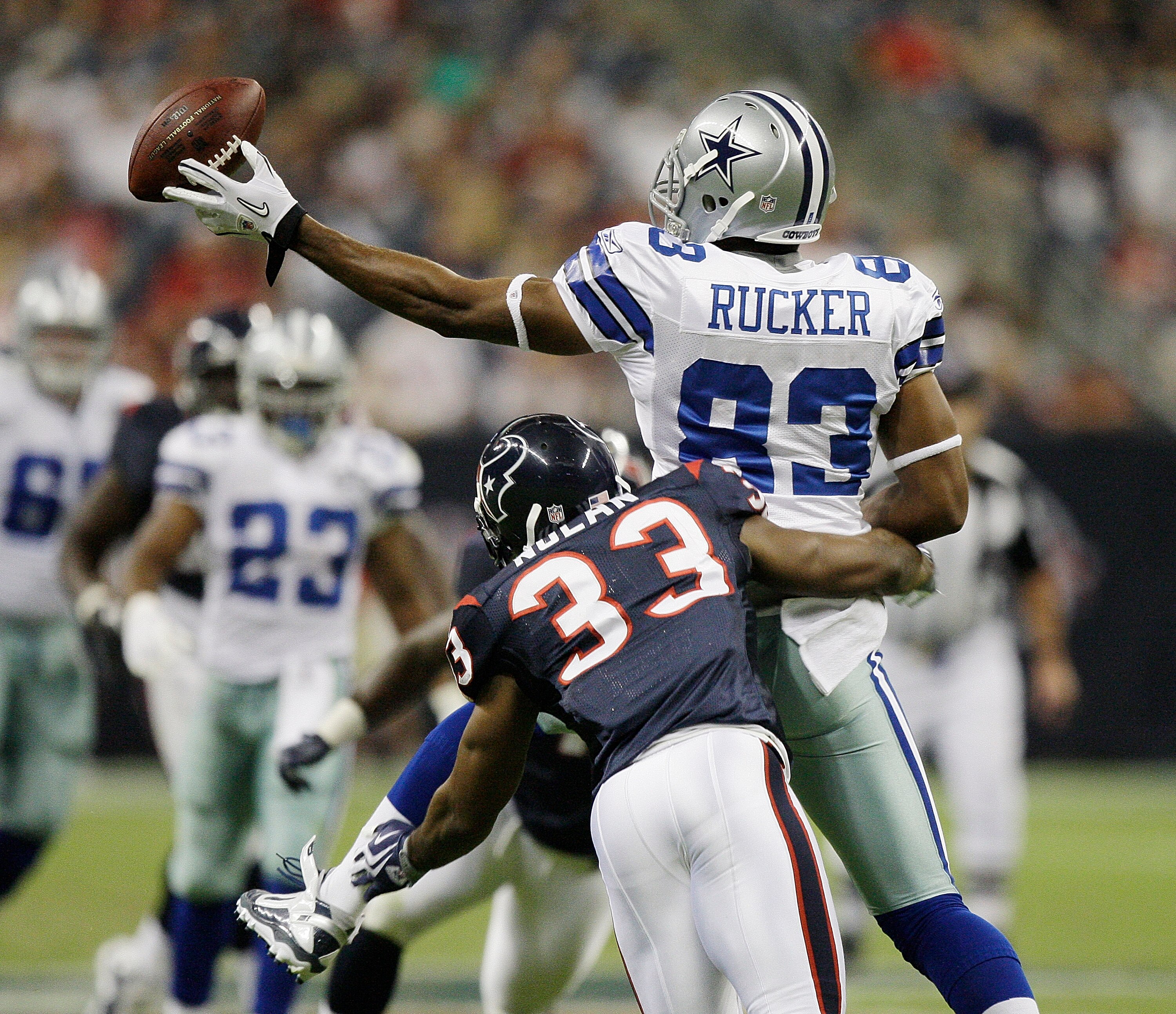 HOUSTON - AUGUST 28: Tight end Martin Rucker #83 of the Dallas Cowboys loses the ball as he his hit by safety Troy Nolan in the third quarter at Reliant Stadium on August 28, 2010 in Houston, Texas. Houston won 23-7. (Photo by Bob Levey/Getty Images)
