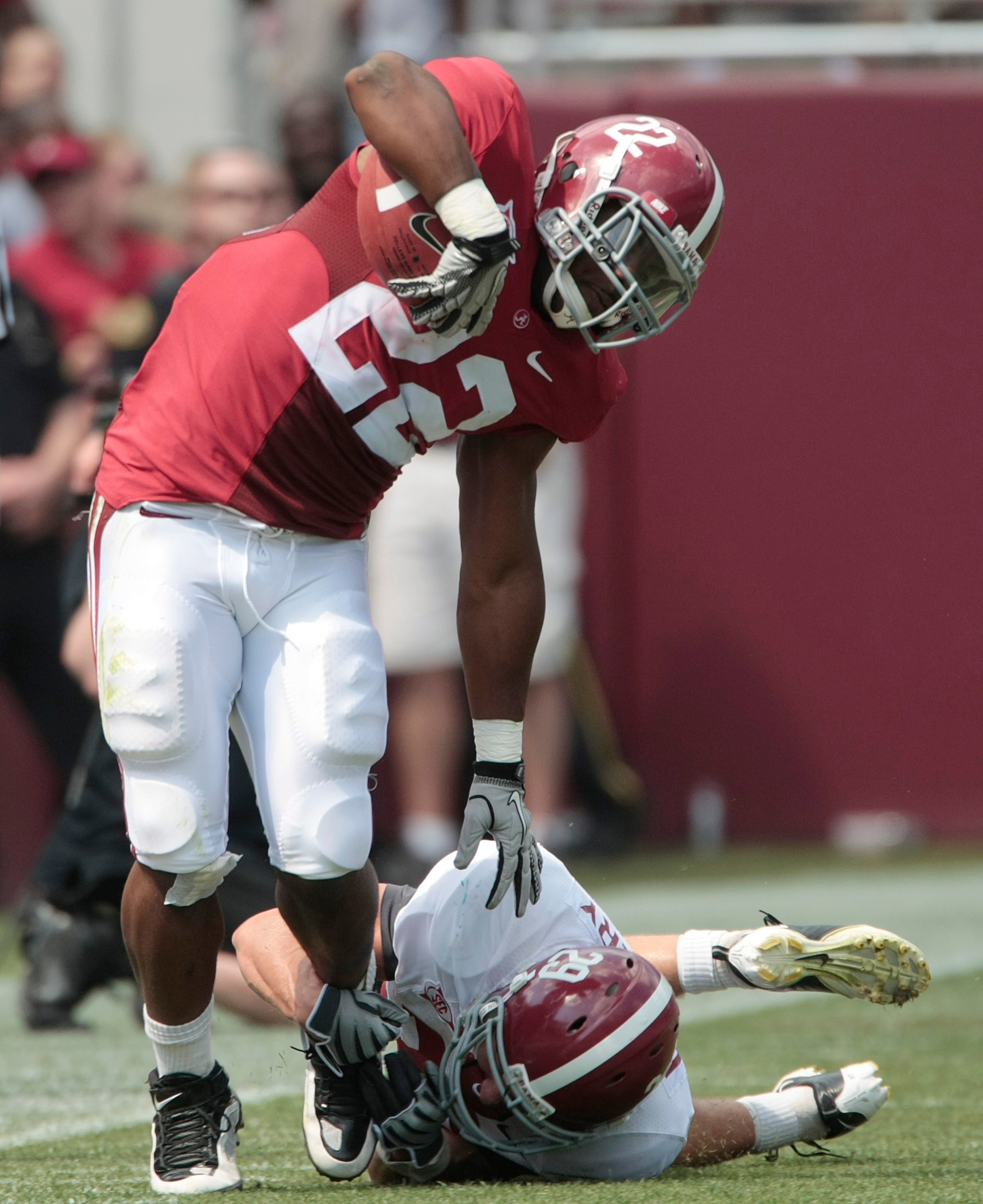 TUSCALOOSA, AL - APRIL 17:  Heisman Trophy running back Mark Ingram #22 of the Alabama Crimson Tide escapes the tackle of defensive back Will Lowery #29 during the Alabama spring game at Bryant Denny Stadium on April 17, 2010 in Tuscaloosa, Alabama. (Phot