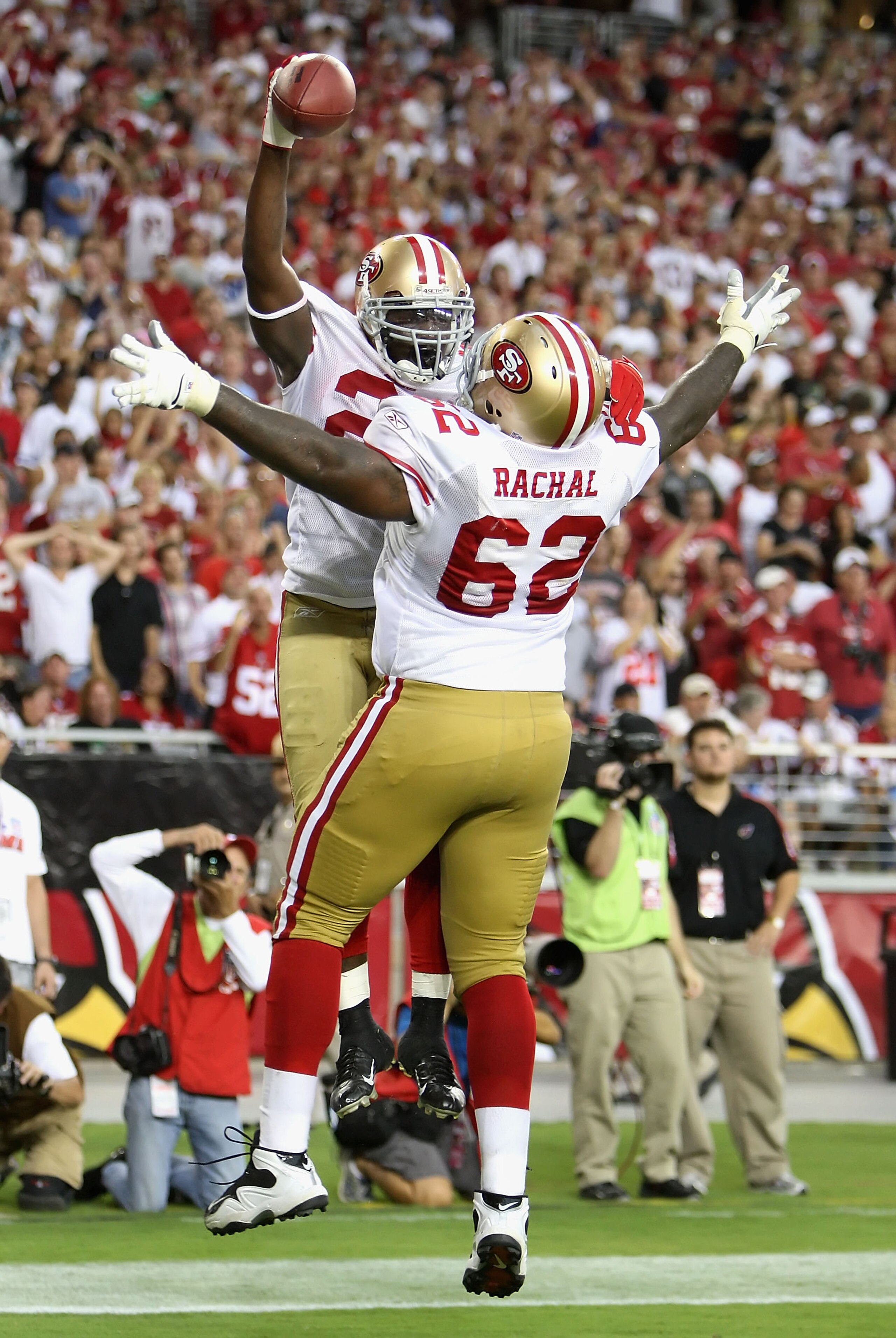 GLENDALE, AZ - SEPTEMBER 13:  Running back Frank Gore #21 of the San Francisco 49ers celebrates with teammate Chilo Rachal #62 after Gore scored a 3 yard touchdown reception against the Arizona Cardinals during the NFL game at the Universtity of Phoenix S