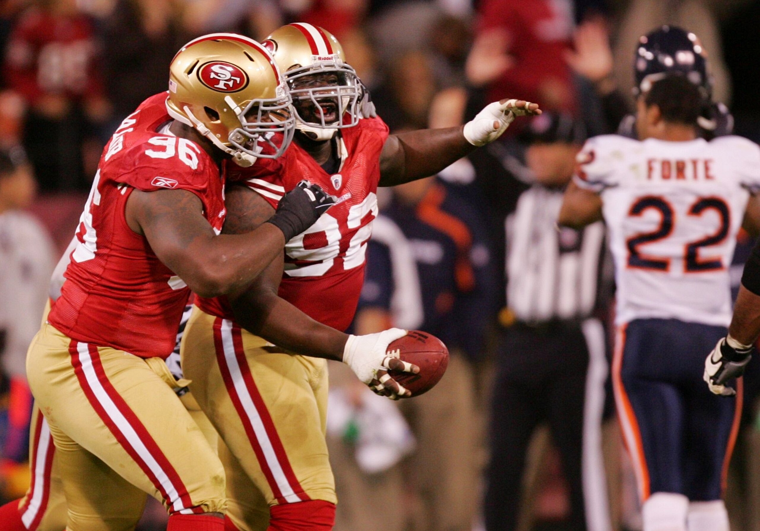 SAN FRANCISCO - NOVEMBER 12: Aubrayo Franklin #92 of the San Francisco 49ers celebrates with teammate Kentwan Balmer #96 after Franklin intercepts a Jay Cutler #6 of the Chicago Bears pass at Candlestick Park on November 12, 2009 in San Francisco, Califor