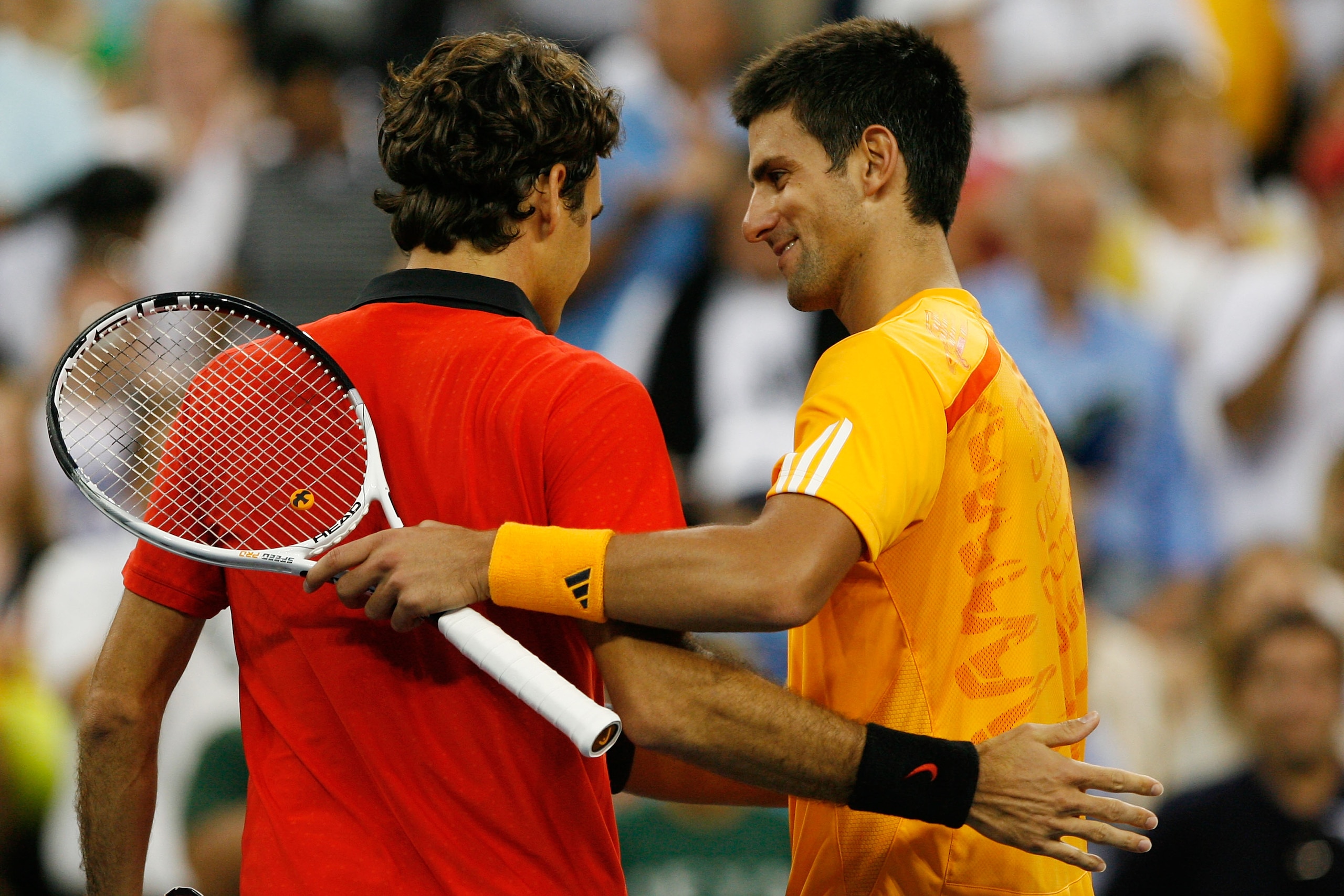 NEW YORK - SEPTEMBER 13:  Roger Federer of Switzerland (L) meets Novak Djokovic of Serbia at the net after the Men's Singles Semifinal match on day fourteen of the 2009 U.S. Open at the USTA Billie Jean King National Tennis Center on September 13, 2009 in