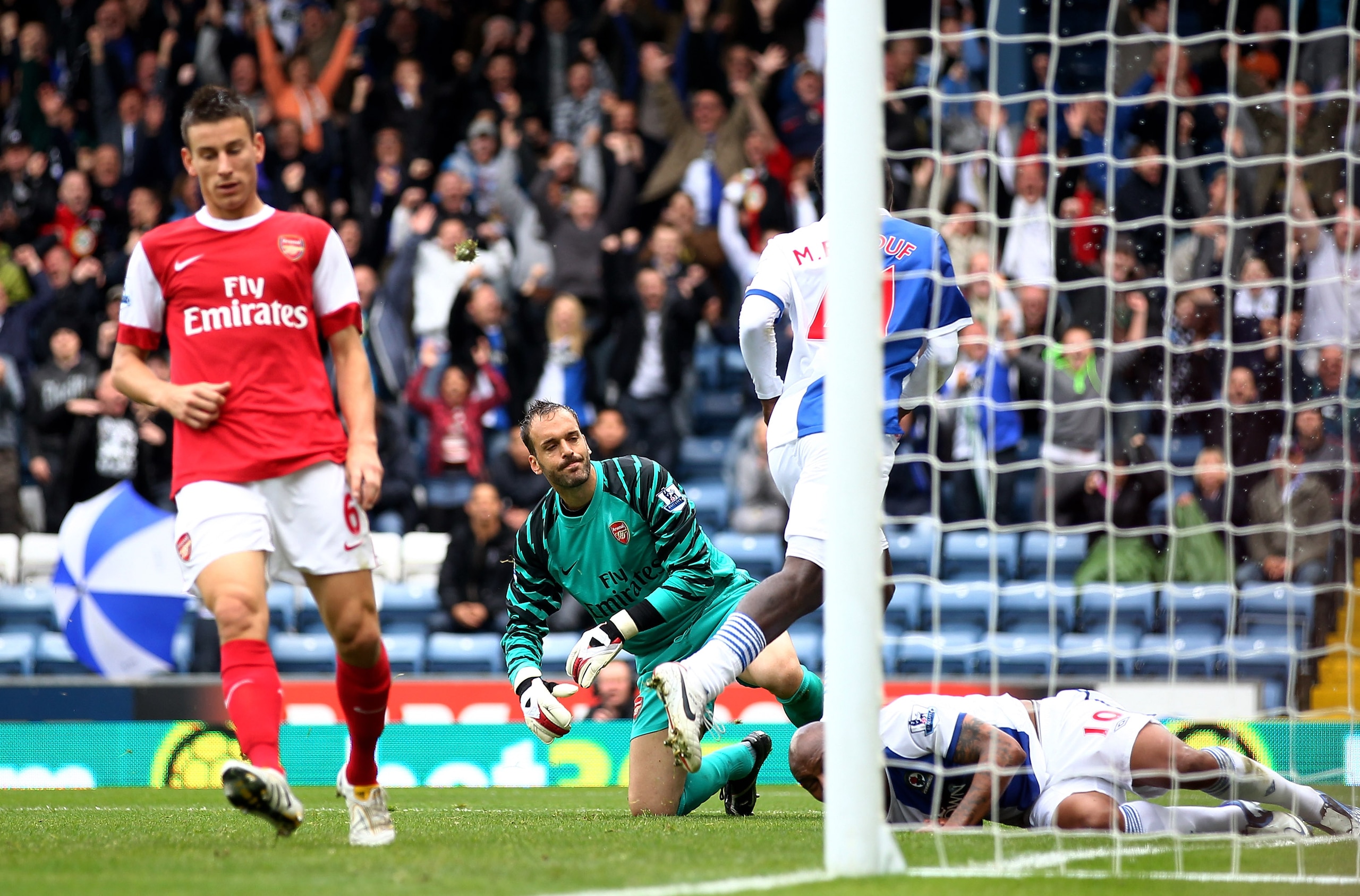 BLACKBURN, ENGLAND - AUGUST 28: Manuel Almunia of Arsenal reacts as Mame Biram Diouf of Blackburn Rovers celebrates scoring his team's first goal during the Barclays Premier League match between Blackburn Rovers and Arsenal at Ewood Park on August 28, 20 BLACKBURN, ENGLAND - AUGUST 28: Manuel Almunia of Arsenal reacts as Mame Biram Diouf of Blackburn Rovers celebrates scoring his team's first goal during the Barclays Premier League match between Blackburn Rovers and Arsenal at Ewood Park on August 28, 20