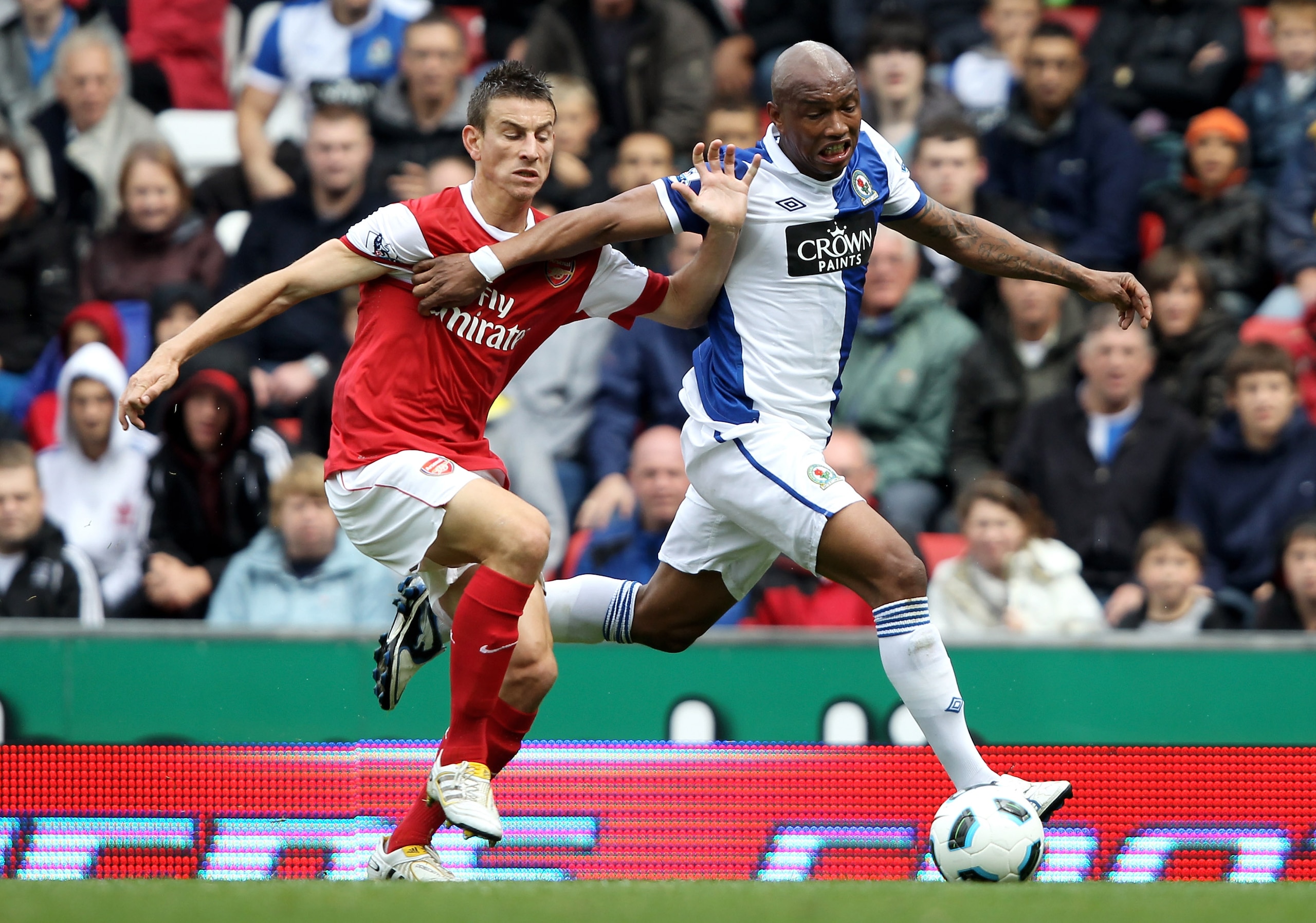 BLACKBURN, ENGLAND - AUGUST 28: Laurent Koscielny of Arsenal tussles for posession with El Hadji Diouf of Blackburn Rovers during the Barclays Premier League match between Blackburn Rovers and Arsenal at Ewood Park on August 28, 2010 in Blackburn, Englan BLACKBURN, ENGLAND - AUGUST 28: Laurent Koscielny of Arsenal tussles for posession with El Hadji Diouf of Blackburn Rovers during the Barclays Premier League match between Blackburn Rovers and Arsenal at Ewood Park on August 28, 2010 in Blackburn, Englan