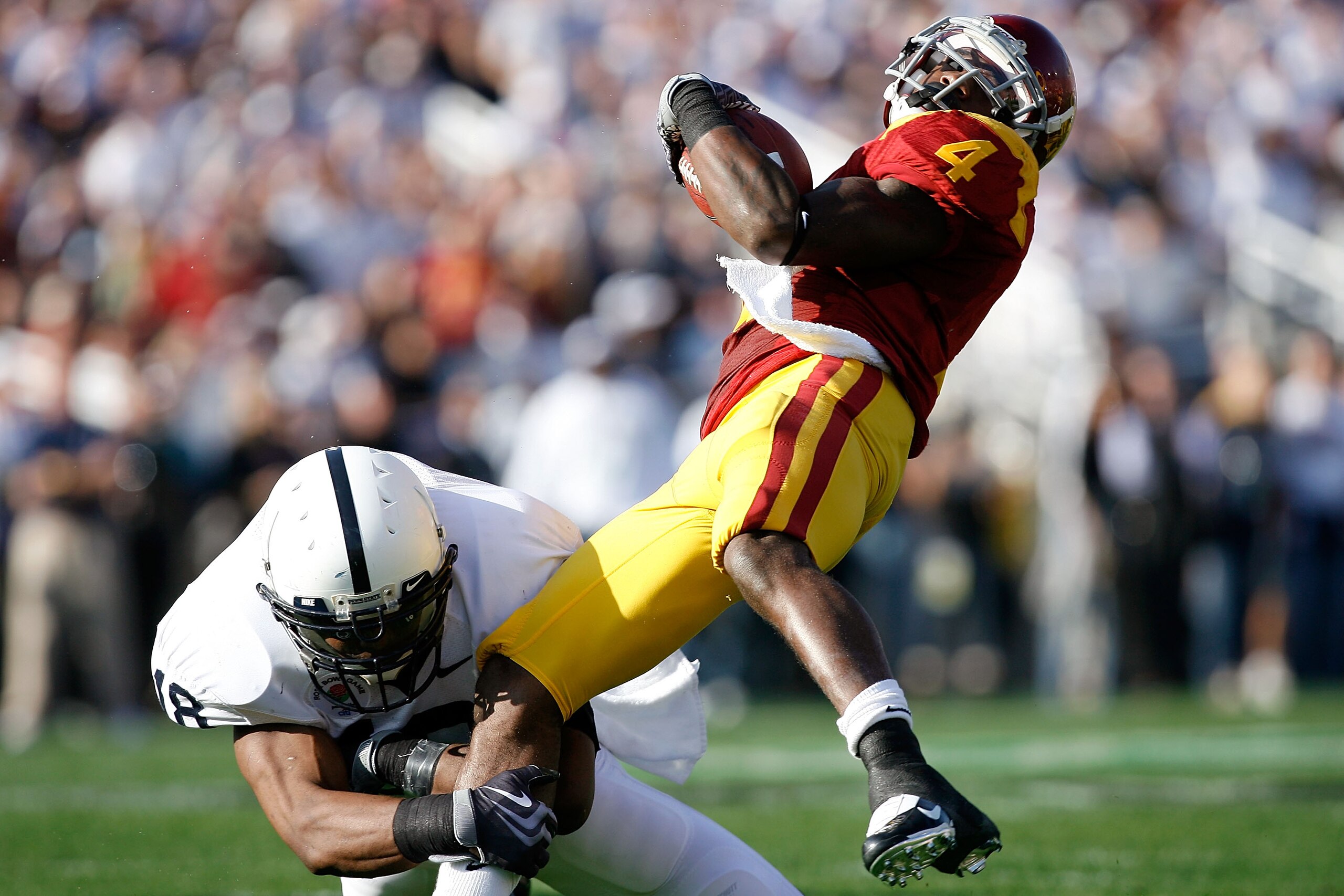 PASADENA, CA - JANUARY 01:  Joe McKnight #4 of the USC Trojans gets tackled by Navorro Bowman #18 of the Penn State Nittany Lions during the 95th Rose Bowl Game presented by Citi on January 1, 2009 at the Rose Bowl in Pasadena, California.  (Photo by Harr