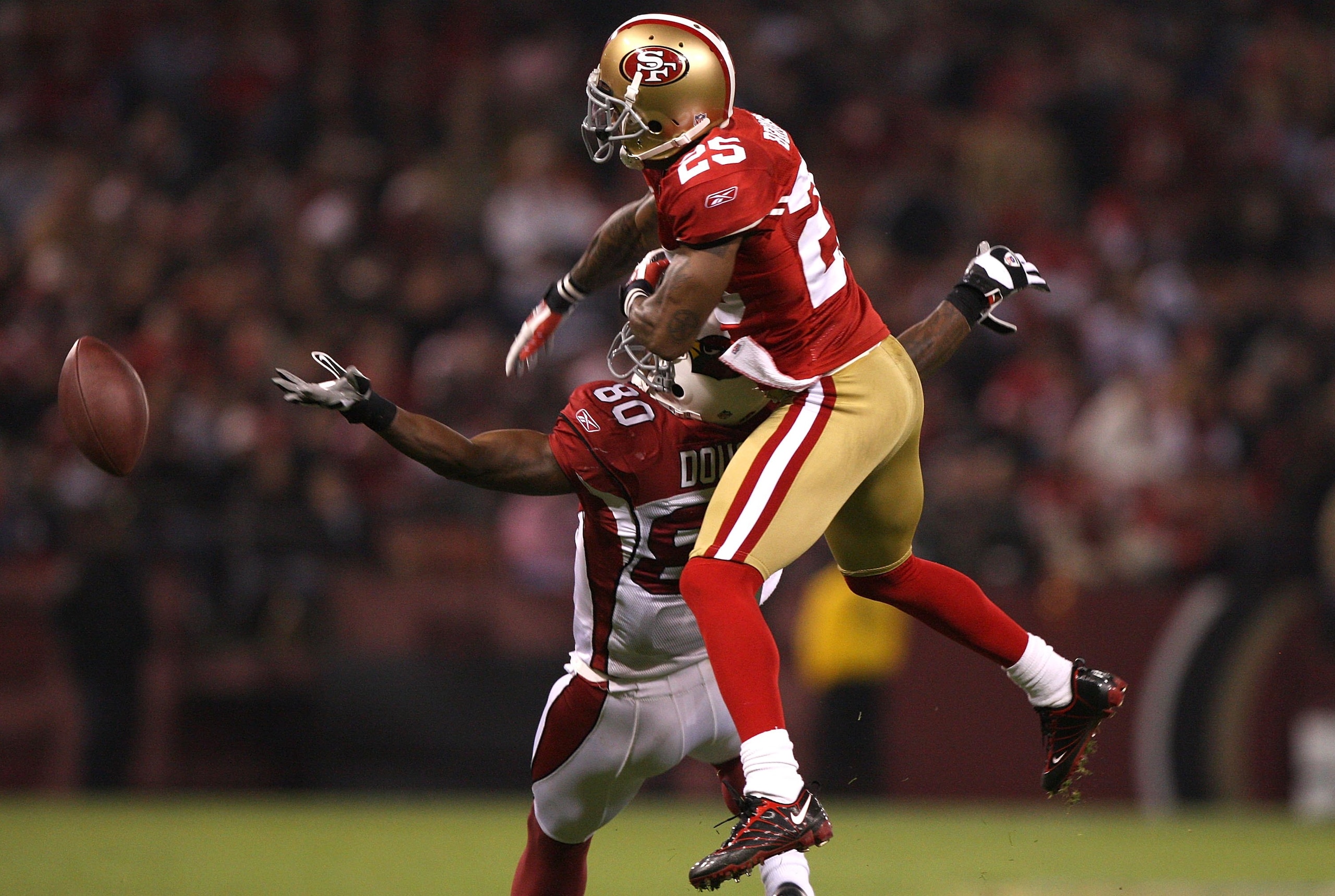 SAN FRANCISCO - DECEMBER 14:  Early Doucet #80 of the Arizona Cardinals misses a pass as it is broken up by Tarell Brown #25 of the San Francisco 49ers in the first half at Candlestick Park on December 14, 2009 in San Francisco, California. The pass was r