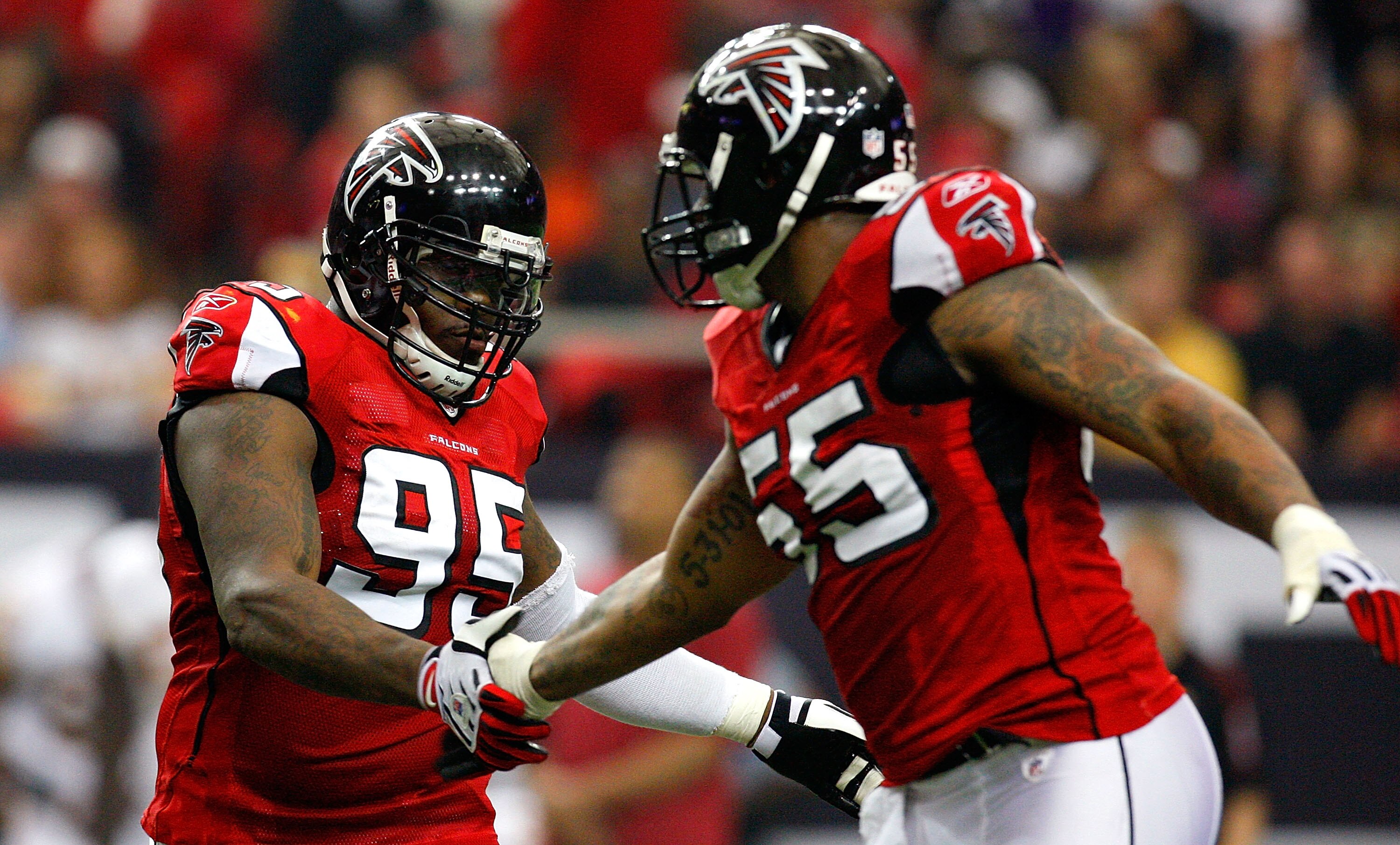 ATLANTA - NOVEMBER 08:  Jonathan Babineaux #95 and John Abraham #55 of the Atlanta Falcons celebrate a sack against the Washington Redskins at Georgia Dome on November 8, 2009 in Atlanta, Georgia.  (Photo by Kevin C. Cox/Getty Images)