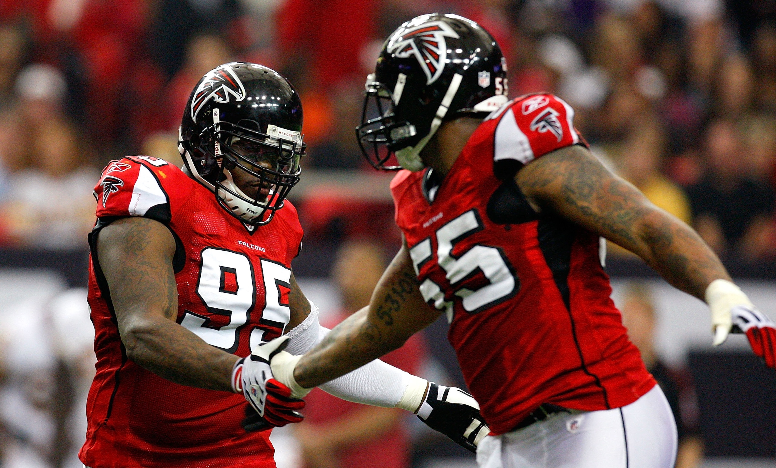 ATLANTA - NOVEMBER 08:  Jonathan Babineaux #95 and John Abraham #55 of the Atlanta Falcons celebrate a sack against the Washington Redskins at Georgia Dome on November 8, 2009 in Atlanta, Georgia.  (Photo by Kevin C. Cox/Getty Images)