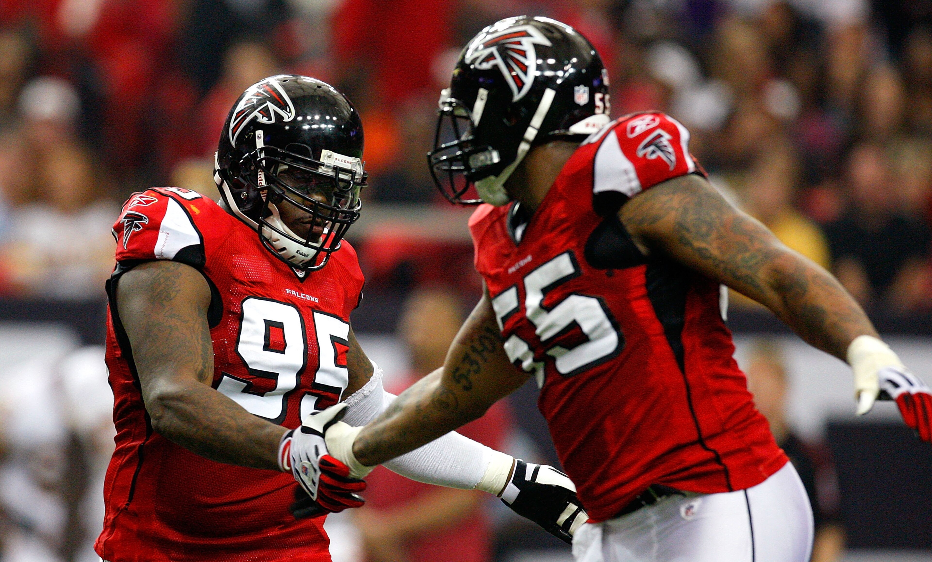 ATLANTA - NOVEMBER 08:  Jonathan Babineaux #95 and John Abraham #55 of the Atlanta Falcons celebrate a sack against the Washington Redskins at Georgia Dome on November 8, 2009 in Atlanta, Georgia.  (Photo by Kevin C. Cox/Getty Images)