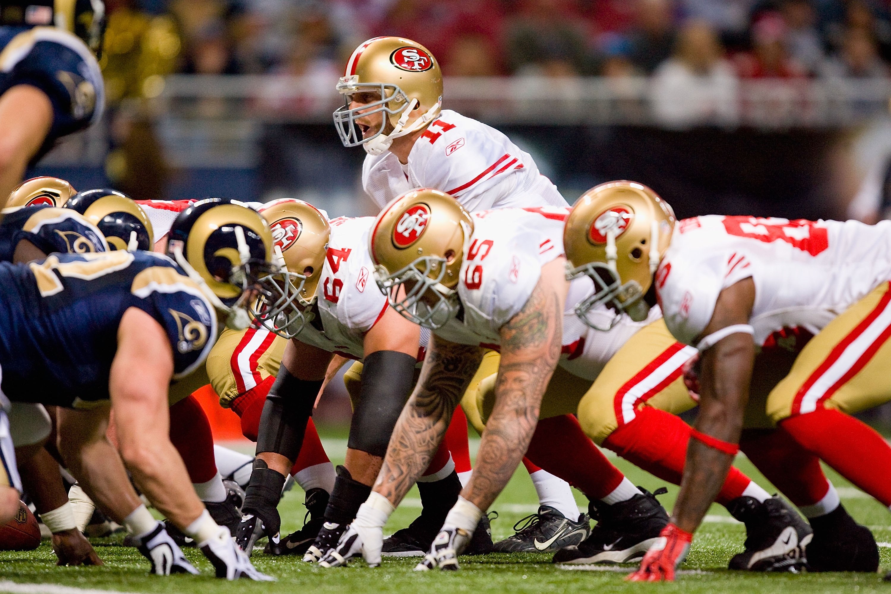 ST. LOUIS - JANUARY 3:  Quarterback Alex Smith #11 of the San Francisco 49ers calls the play at the line of scrimmage during the game against the St. Louis Rams at the Edward Jones Dome on January 3, 2010 in St. Louis, Missouri.  The 49ers beat the Rams 2