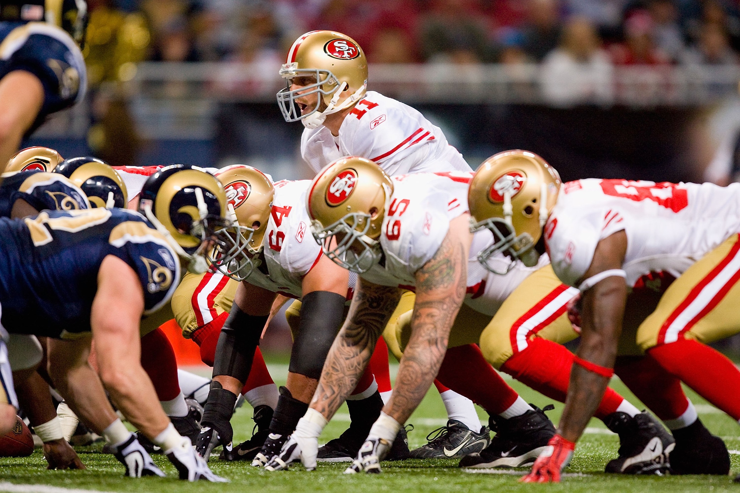 ST. LOUIS - JANUARY 3:  Quarterback Alex Smith #11 of the San Francisco 49ers calls the play at the line of scrimmage during the game against the St. Louis Rams at the Edward Jones Dome on January 3, 2010 in St. Louis, Missouri.  The 49ers beat the Rams 2