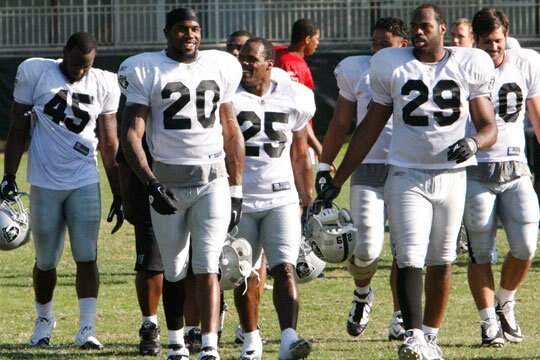 Darren McFadden, Rock Cartwright, and Michael Bush leave the field after practice.