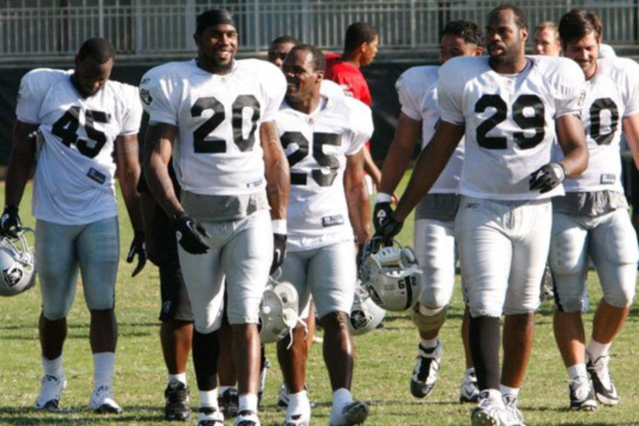 Darren McFadden, Rock Cartwright, and Michael Bush leave the field after practice.
