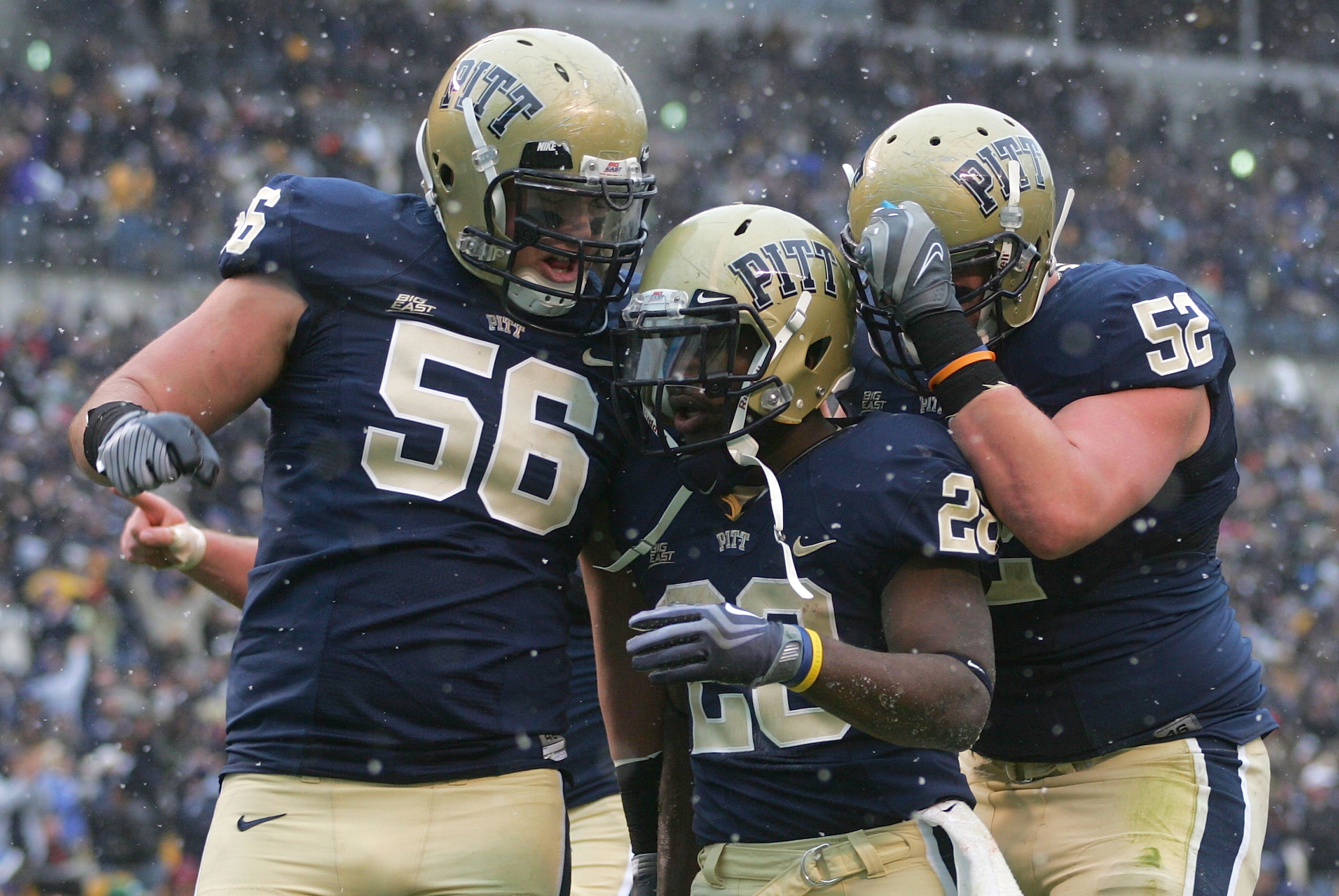 PITTSBURGH - DECEMBER 05: Dion Lewis #28 celebrates with teammates Joe Thomas #56 and Lucas Nix #52 of the University of Pittsburgh Panthers in the first quarter after scoring a touchdown against the Cincinnati Bearcats on December 5, 2009 at Heinz Field