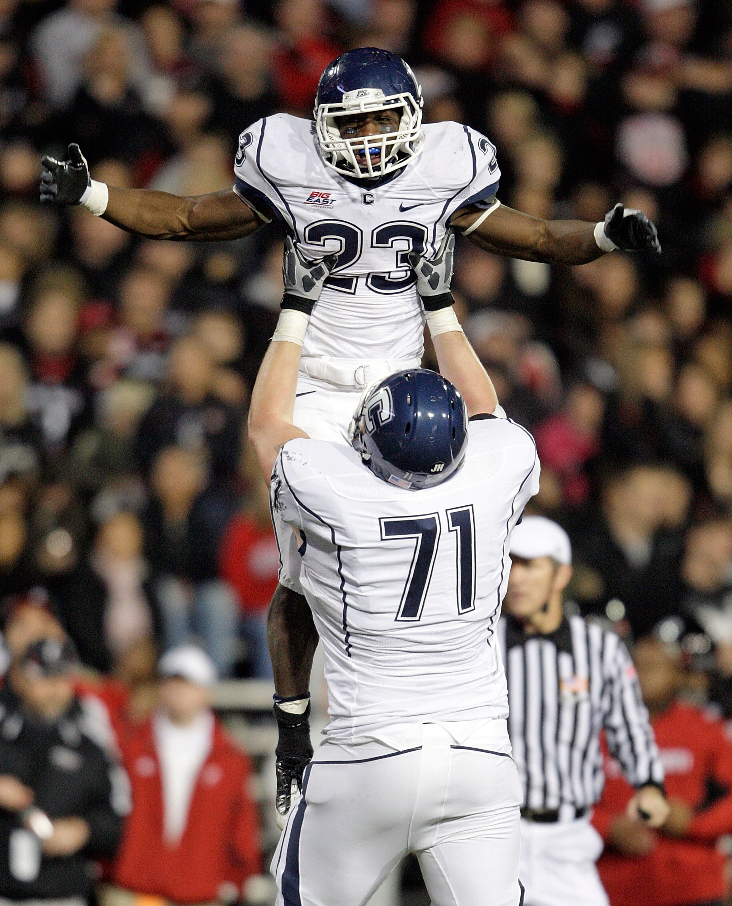 CINCINNATI - NOVEMBER 07:  Jordan Todman #23 of the Connecticut Huskies celebrates with Mike Ryan #71 after running for a touchdownl against the Cincinnati Bearcats during the Big East Conference game at Nippert Stadium on November 7, 2009 in Cincinnati,