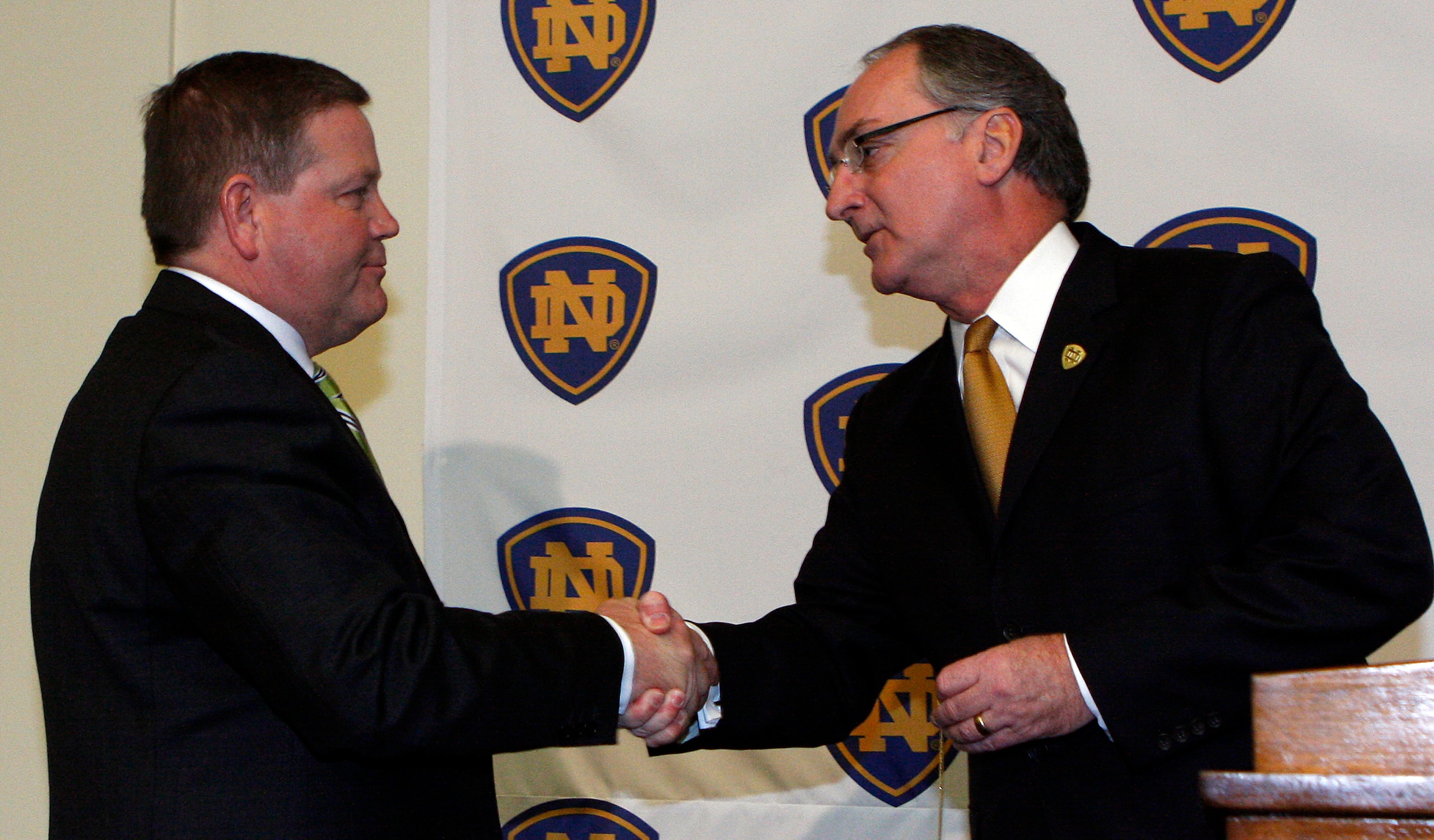 SOUTH BEND, IN - DECEMBER 11: Notre Dame atheletic director Jack Swarbrick (R) greets Brian Kelly as he is introduced as the new football head coach at Notre Dame University on December 11, 2009 in South Bend, Indiana.  Kelly most recently led the Univers