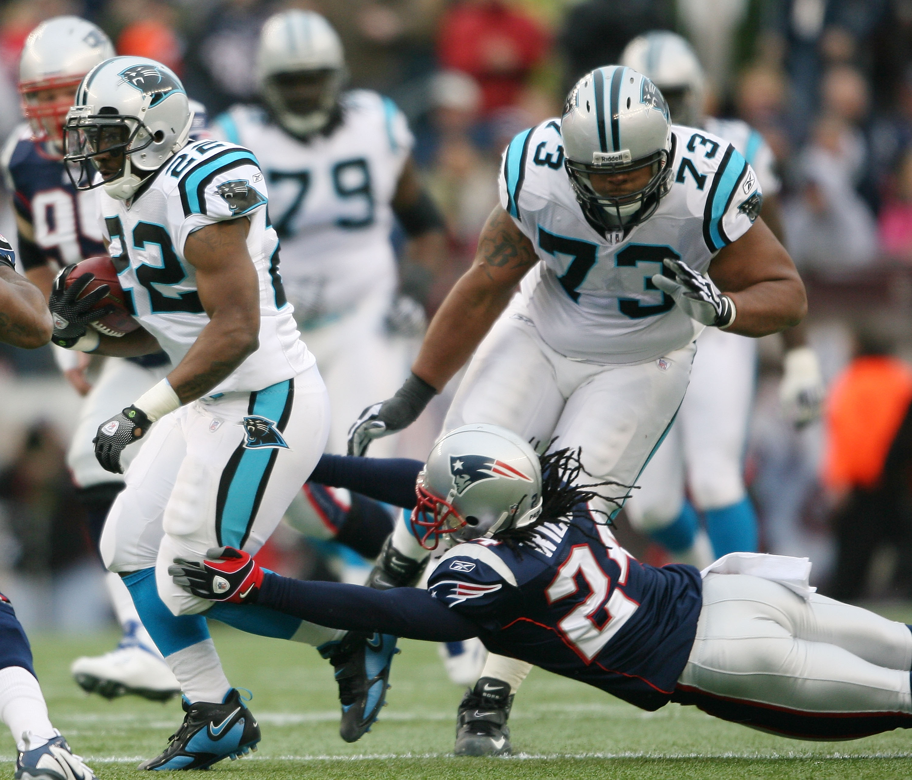 FOXBORO, MA - DECEMBER 13:  Tyrell Sutton #22 of the Carolina Panthers carries the ball as Jonathan Wilhite #24 of the New England Patriots defends on December 13, 2009 at Gillette Stadium in Foxboro, Massachusetts.  (Photo by Elsa/Getty Images)