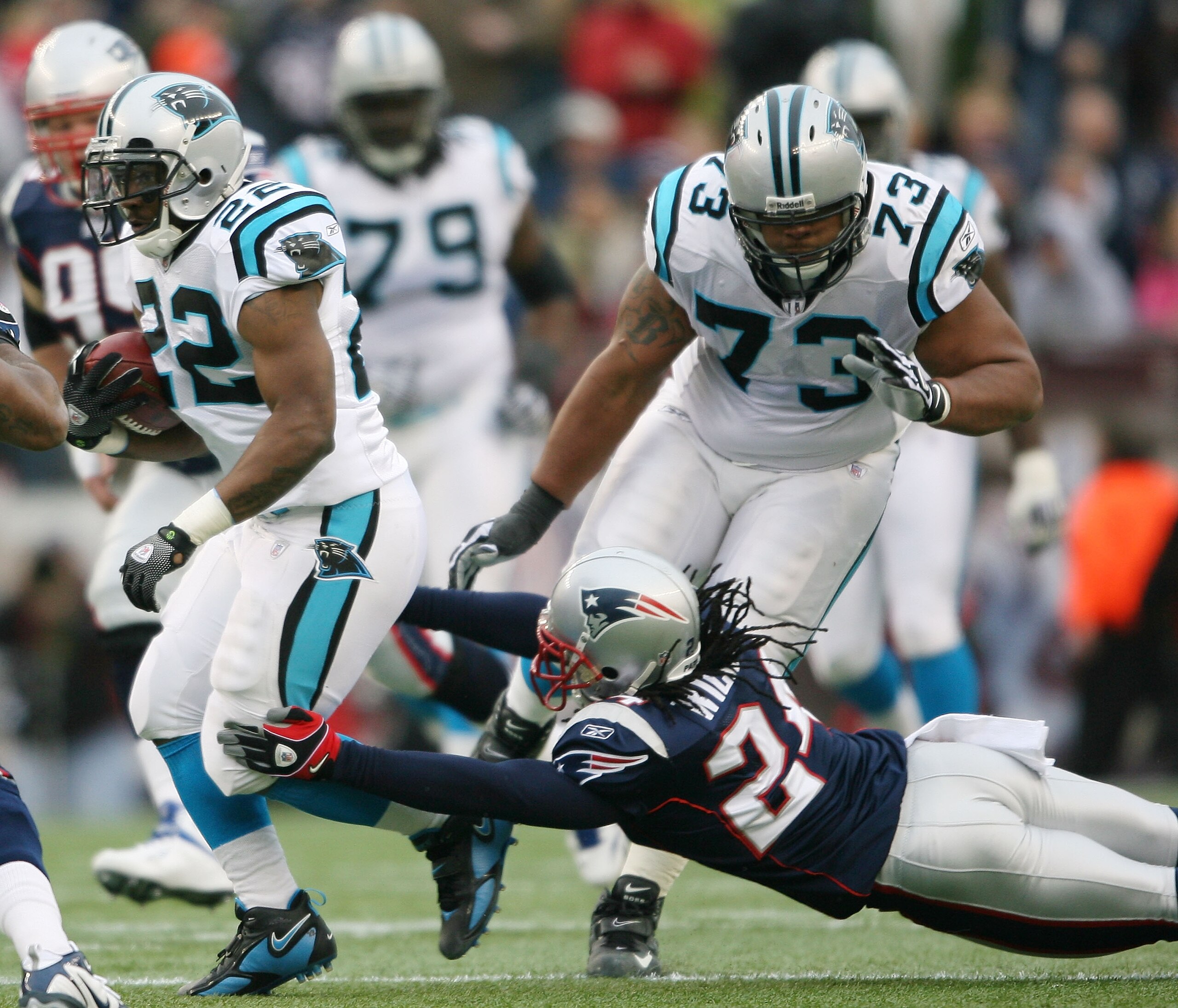 FOXBORO, MA - DECEMBER 13:  Tyrell Sutton #22 of the Carolina Panthers carries the ball as Jonathan Wilhite #24 of the New England Patriots defends on December 13, 2009 at Gillette Stadium in Foxboro, Massachusetts.  (Photo by Elsa/Getty Images)