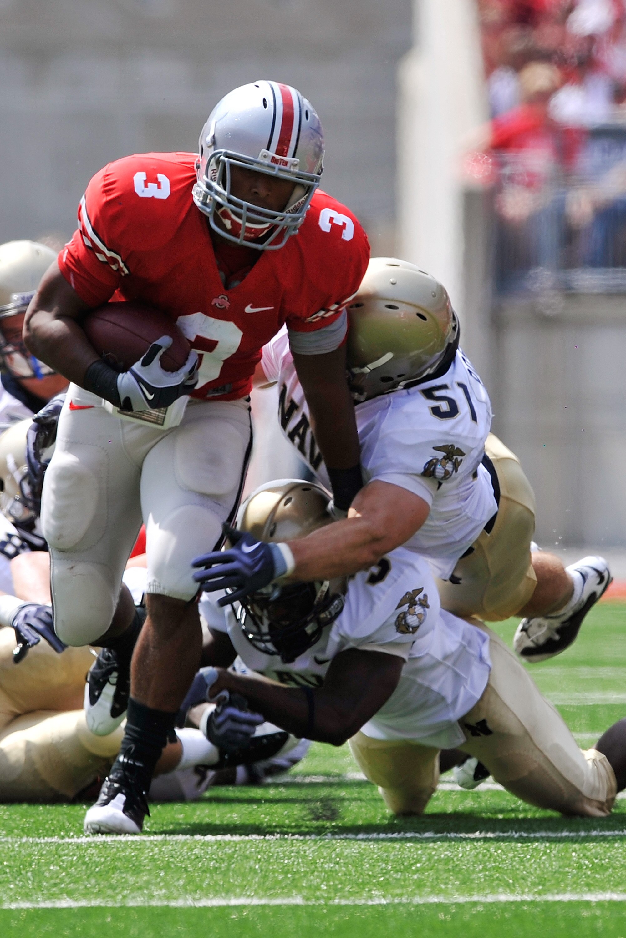 COLUMBUS, OH - SEPTEMBER 05:  Running back Brandon Saine #3 of the Ohio State Buckeyes fights off a tackle by the Navy Midshipmen at Ohio Stadium on September 5, 2009 in Columbus, Ohio.  (Photo by Jamie Sabau/Getty Images)