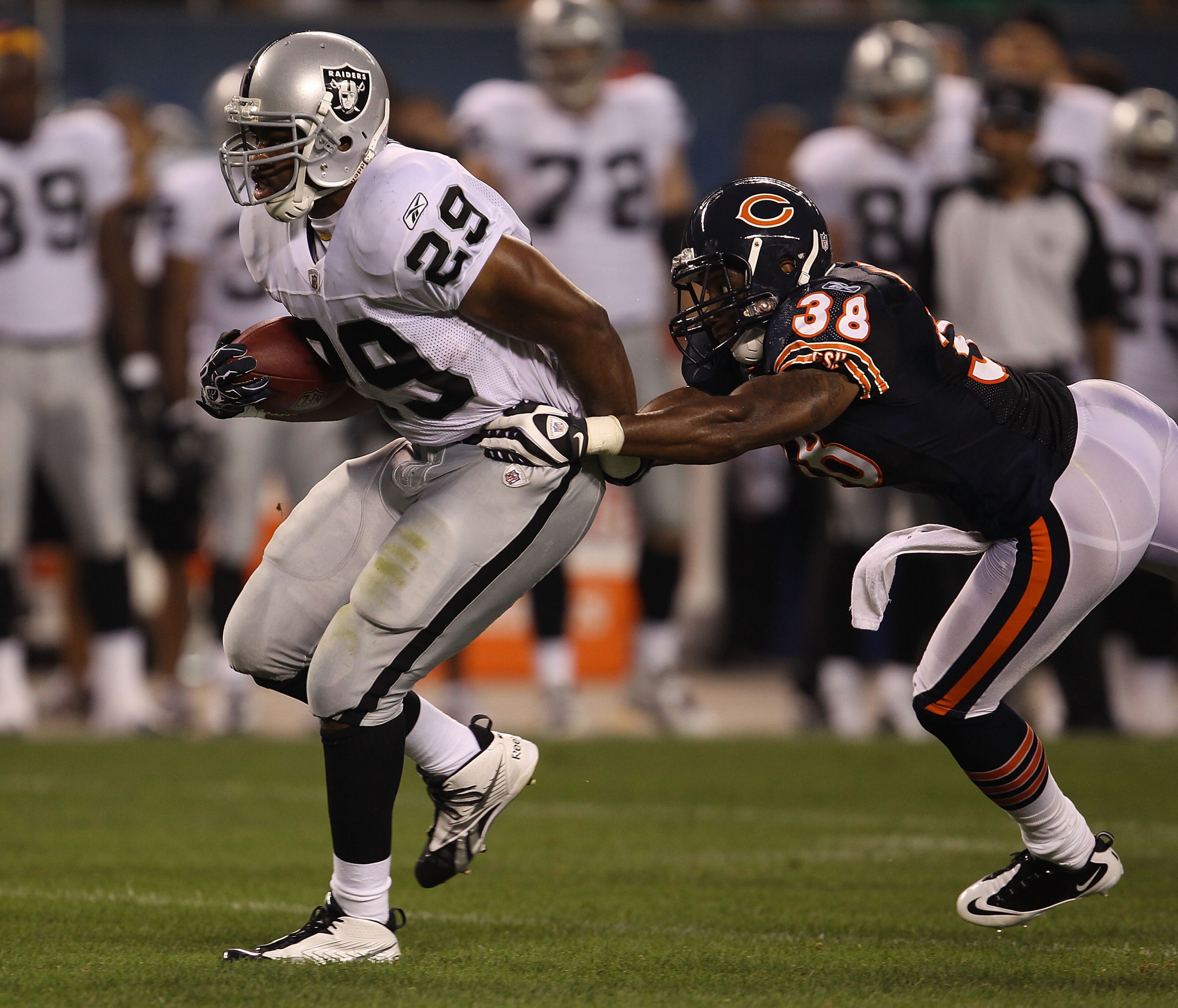 CHICAGO - AUGUST 21: Michael Bush #29 of the Oakland Raiders breaks away from Danieal Manning #38 of the Chicago Bears during a preseason game at Soldier Field on August 21, 2010 in Chicago, Illinois. The Raiders defeated the Bears 32-17. (Photo by Jonath CHICAGO - AUGUST 21: Michael Bush #29 of the Oakland Raiders breaks away from Danieal Manning #38 of the Chicago Bears during a preseason game at Soldier Field on August 21, 2010 in Chicago, Illinois. The Raiders defeated the Bears 32-17. (Photo by Jonath