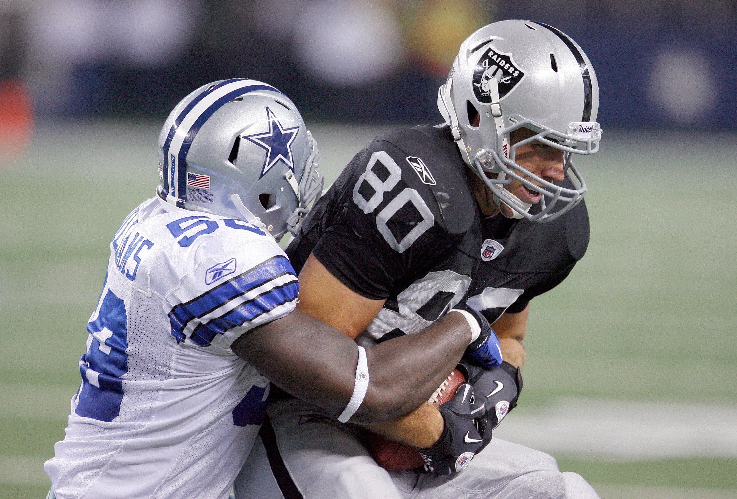 ARLINGTON, TX - AUGUST 12: Zach Miller #80 of the Oakland Raiders carries the ball against Jason Williams #58 of the Dallas Cowboys during the preseason game at Dallas Cowboys Stadium on August 12, 2010 in Arlington, Texas. The Raiders beat the Cowboys ARLINGTON, TX - AUGUST 12: Zach Miller #80 of the Oakland Raiders carries the ball against Jason Williams #58 of the Dallas Cowboys during the preseason game at Dallas Cowboys Stadium on August 12, 2010 in Arlington, Texas. The Raiders beat the Cowboys