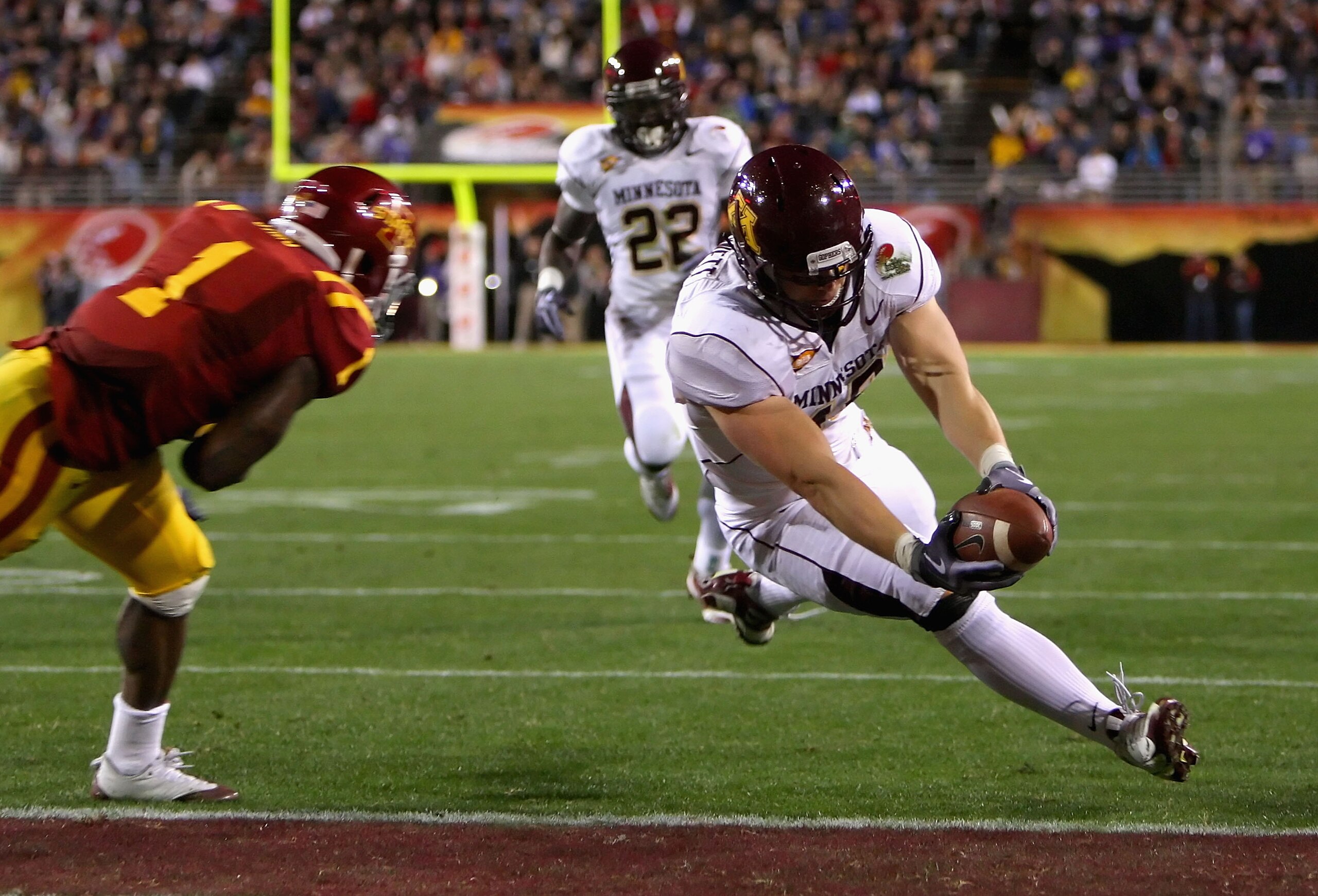 TEMPE, AZ - DECEMBER 31:  Tight end Nick Tow-Arnett #48 of the Minnesota Golden Gophers dives into the endzone to score on a 23 yard reception past David Sims #1 of the Iowa State Cyclones during the Insight Bowl at Arizona Stadium on December 31, 2009 in