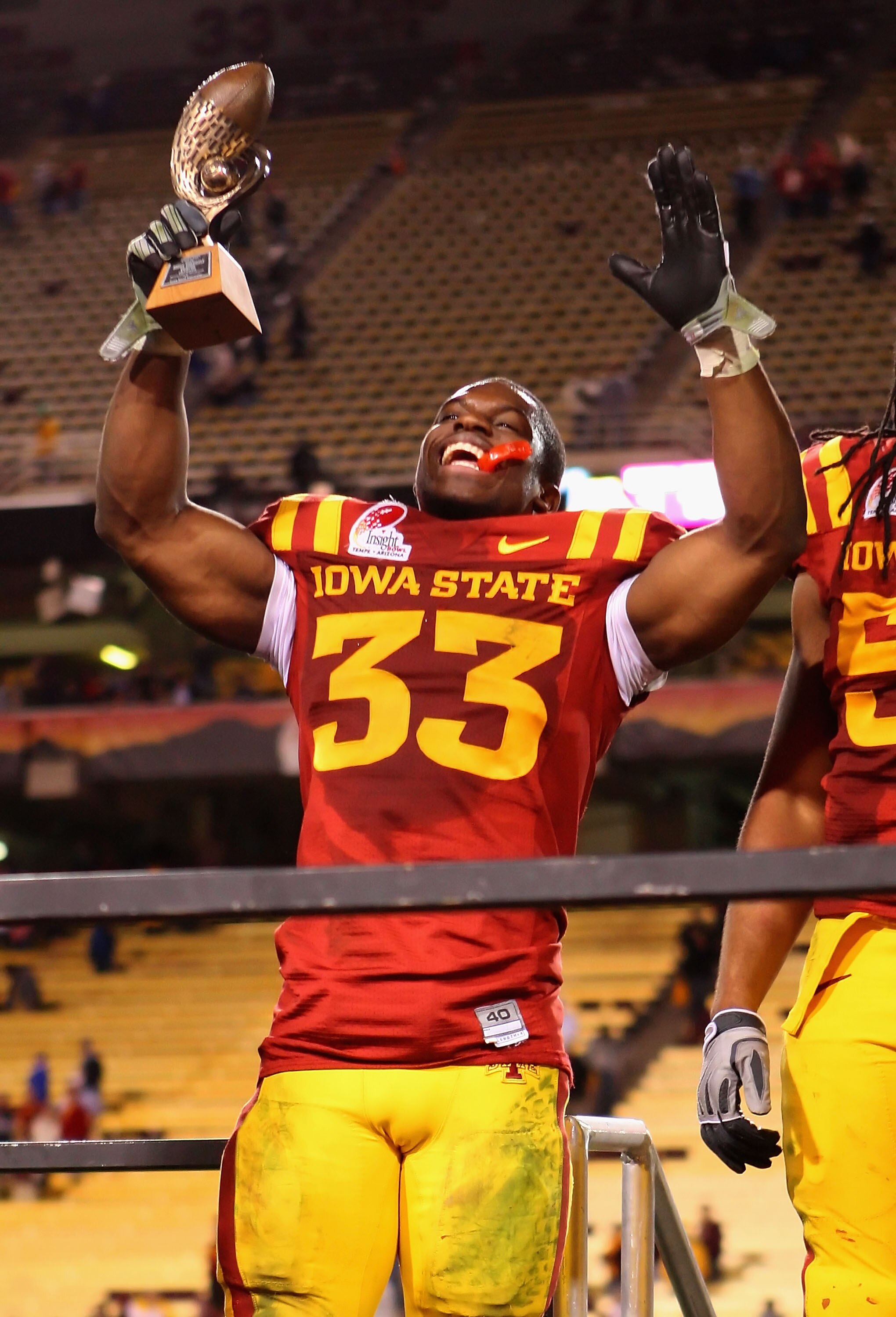 TEMPE, AZ - DECEMBER 31:  Runningback Alexander Robinson #33 of the Iowa State Cyclones celebrates with the Insight Bowl offensive player award after defeating the Minnesota Golden Gophers at Arizona Stadium on December 31, 2009 in Tempe, Arizona. The Cyc