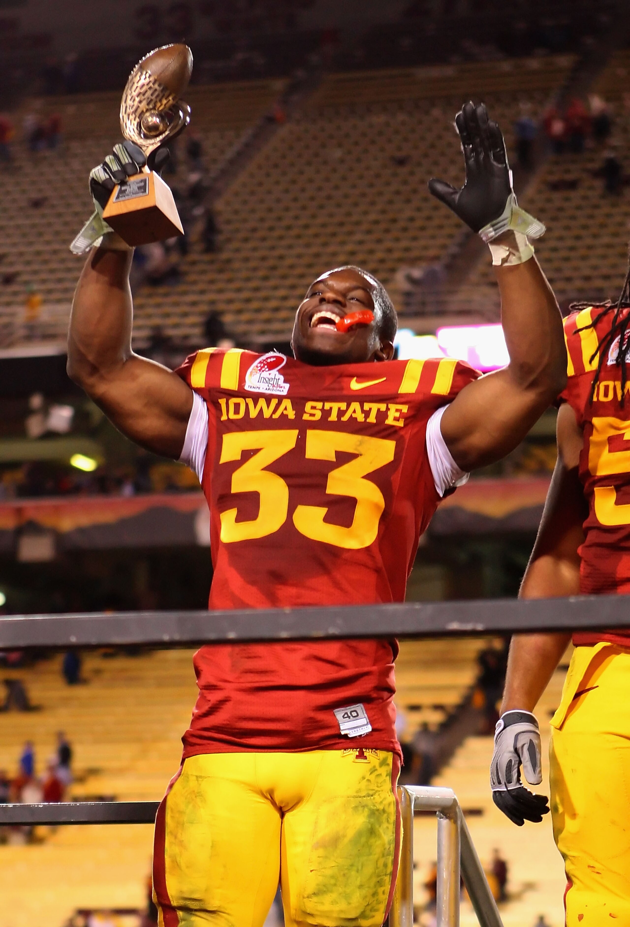 TEMPE, AZ - DECEMBER 31:  Runningback Alexander Robinson #33 of the Iowa State Cyclones celebrates with the Insight Bowl offensive player award after defeating the Minnesota Golden Gophers at Arizona Stadium on December 31, 2009 in Tempe, Arizona. The Cyc